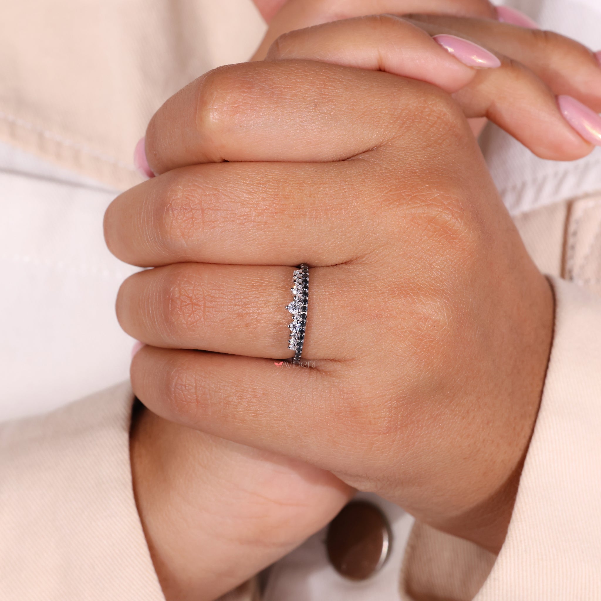 White gold moissanite wedding band with a round cut eternity band design.