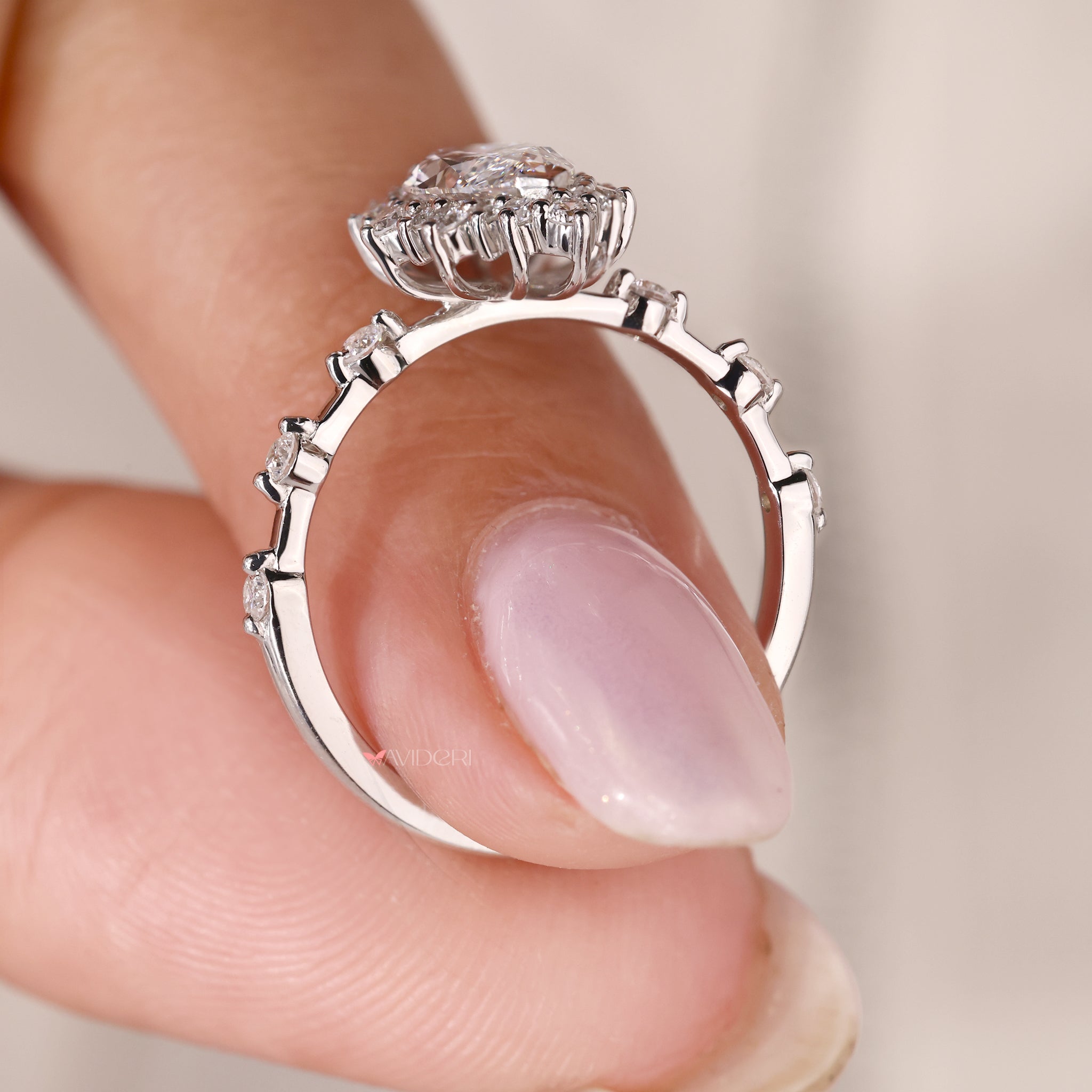 white gold engagement ring with round and marquise diamonds in halo setting.