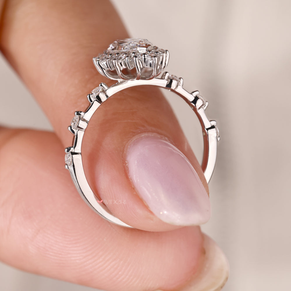 white gold engagement ring with round and marquise diamonds in halo setting.