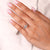 Side diamond engagement ring featuring a pear center stone with lab grown diamonds.
