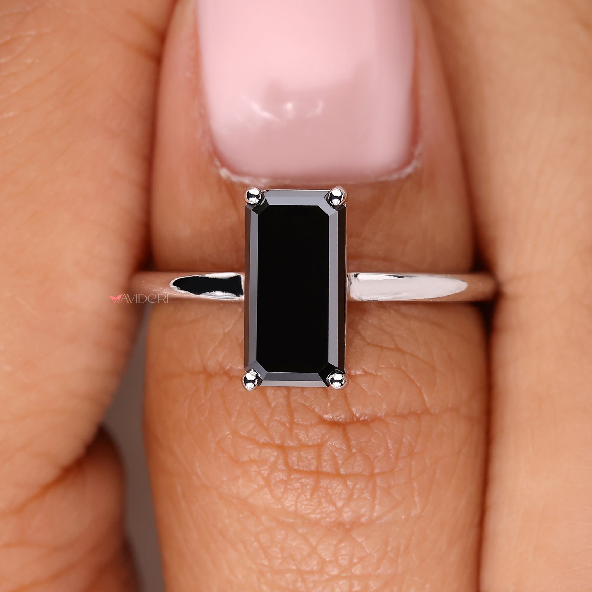 Black diamond ring featuring a sophisticated emerald portrait design.