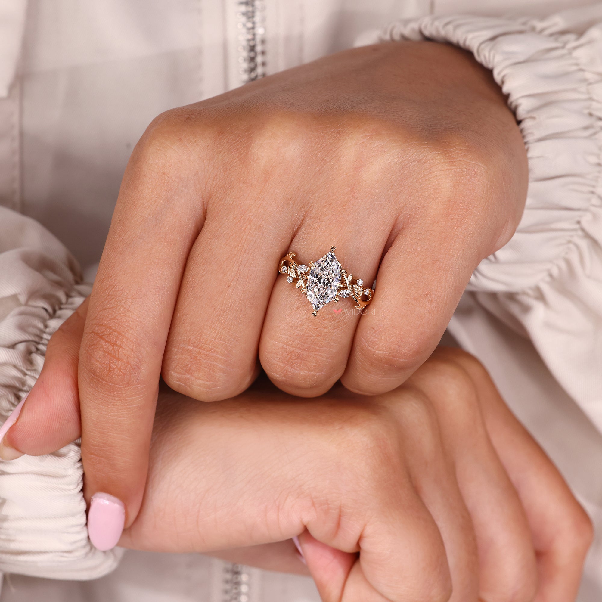 Diamond cluster engagement ring with marquise and round side stone.