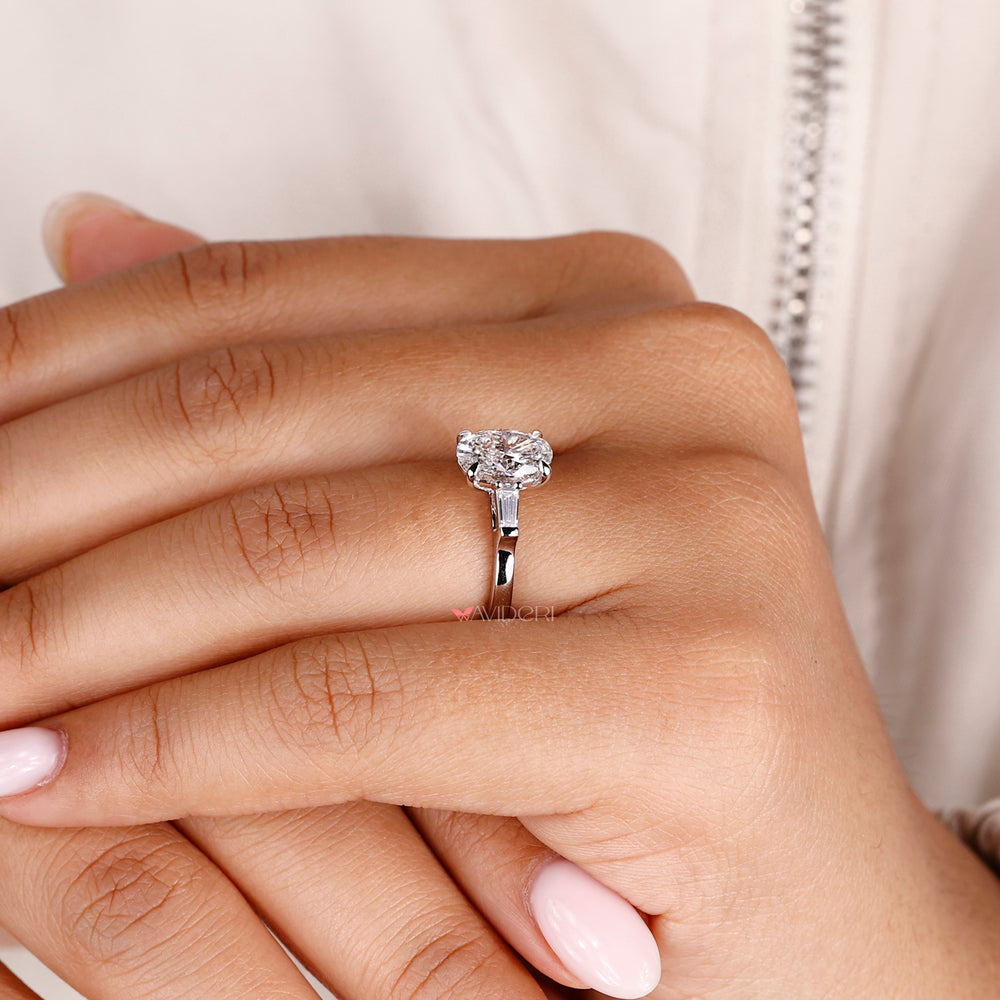 Handmade ring featuring an oval shaped diamond in a secure setting.
