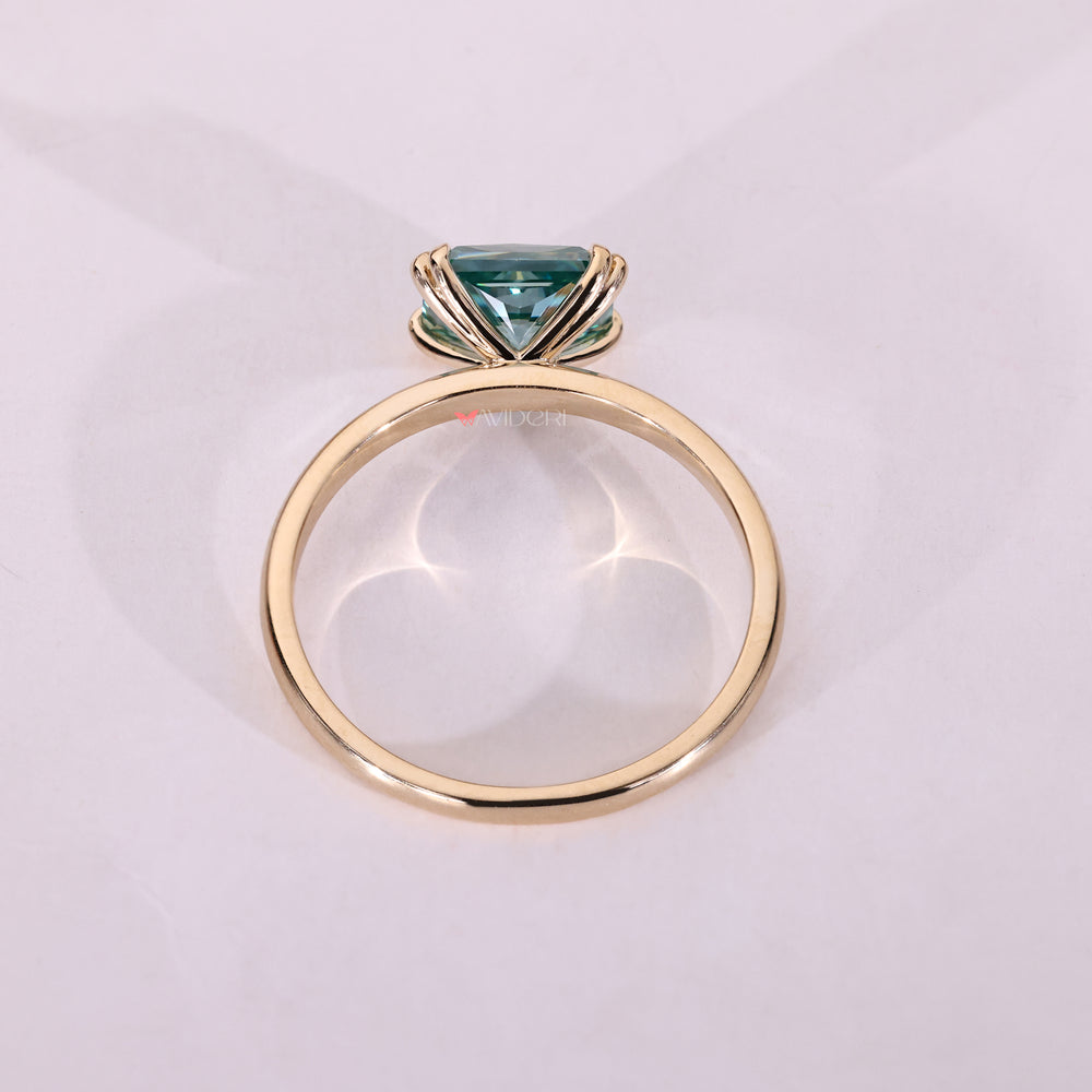 Yellow gold moissanite ring featuring a radiant cut stone.