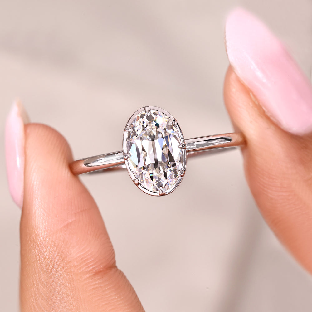 Oval old European cut engagement ring with bezel setting.