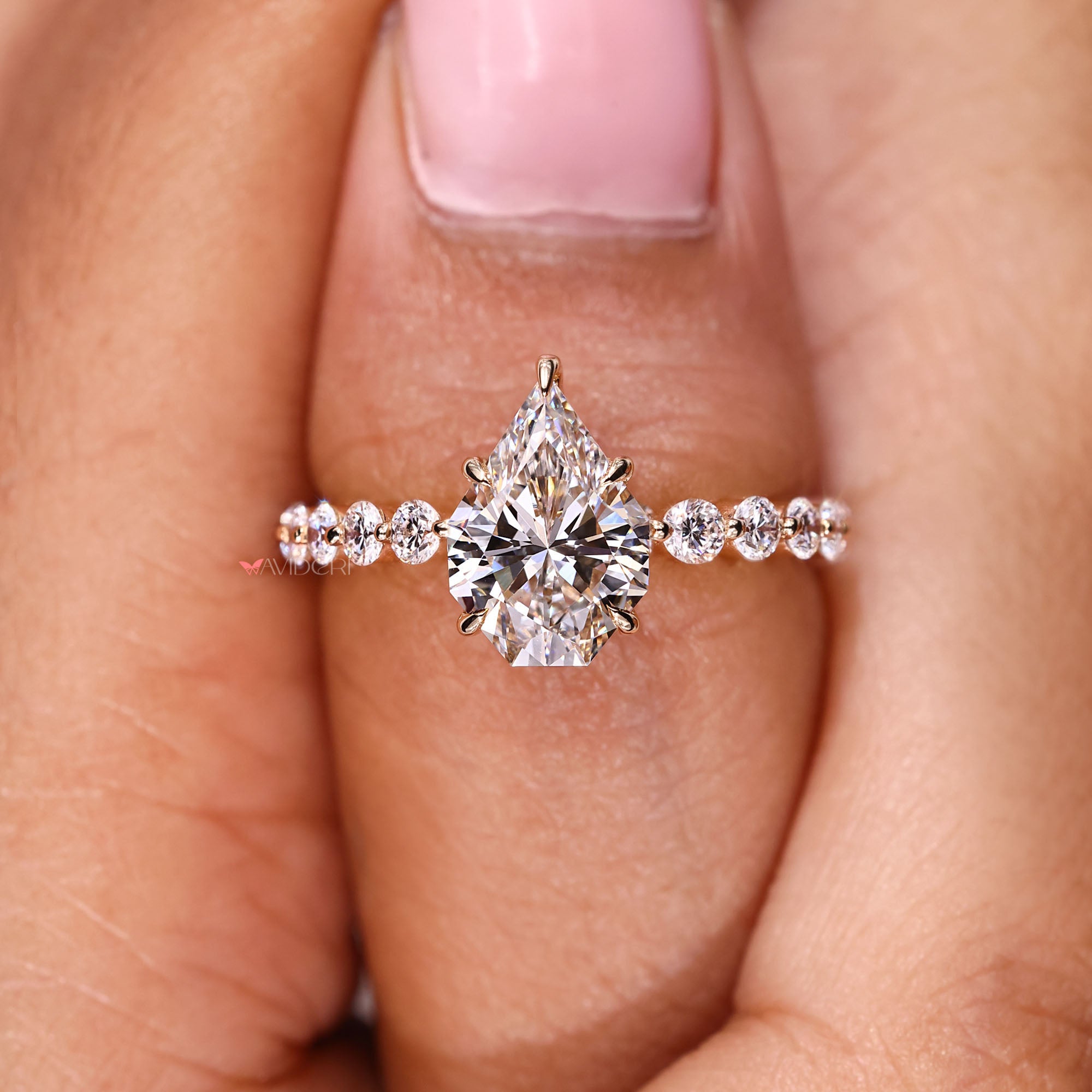 Handmade ring with shared prong round diamonds.