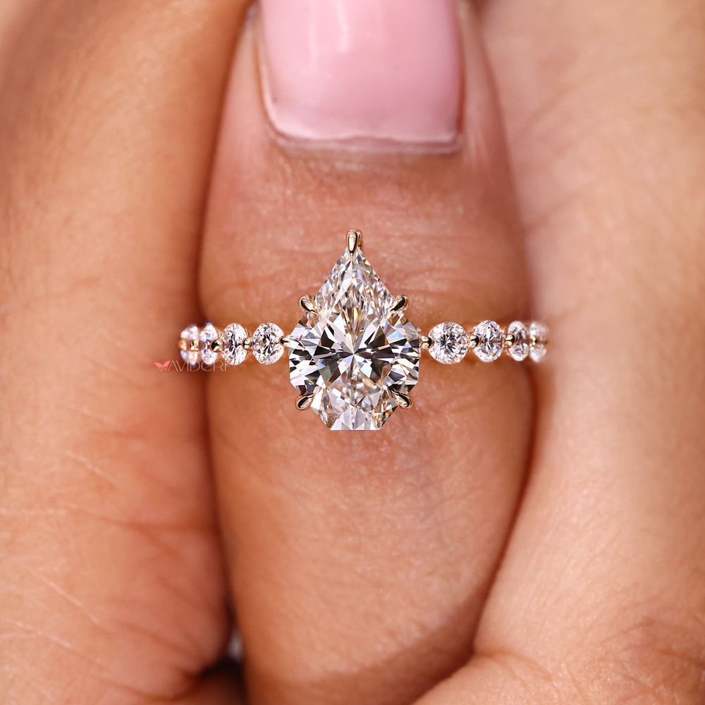 Handmade ring with shared prong round diamonds.
