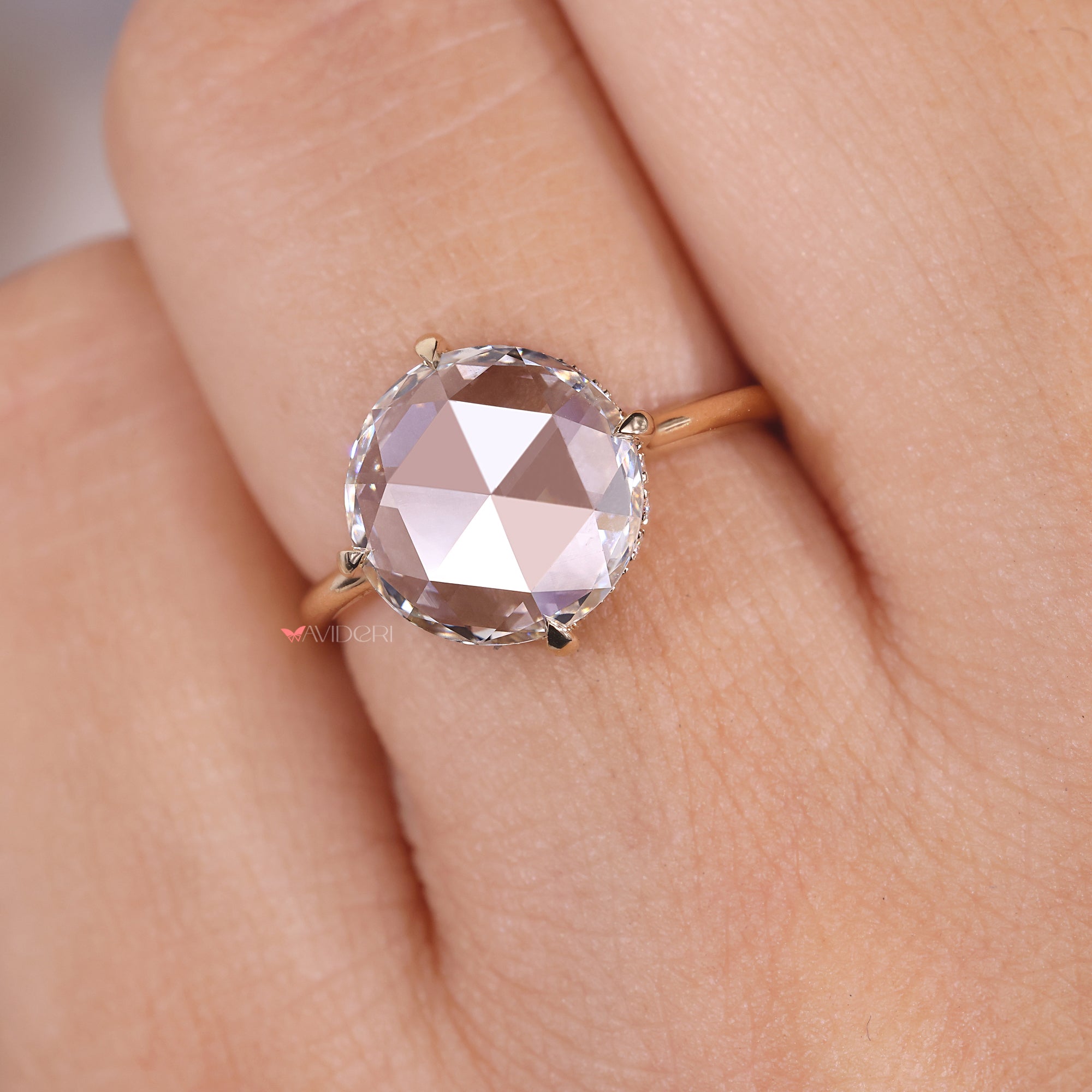 Compass prong setting engagement ring with a round diamond, ensuring a secure and stylish hold.
