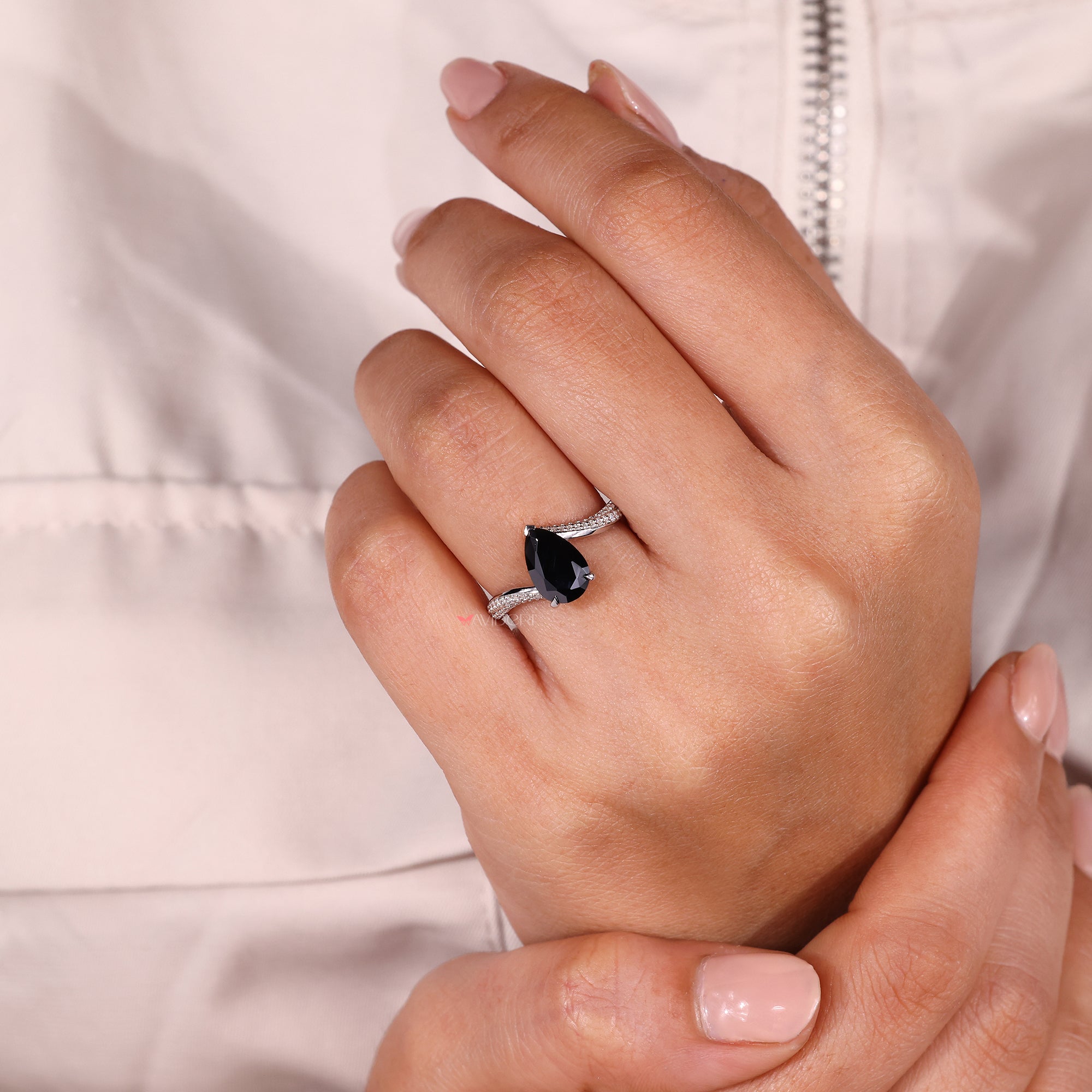 Black pear-shaped engagement ring featuring a dramatic and bold design.