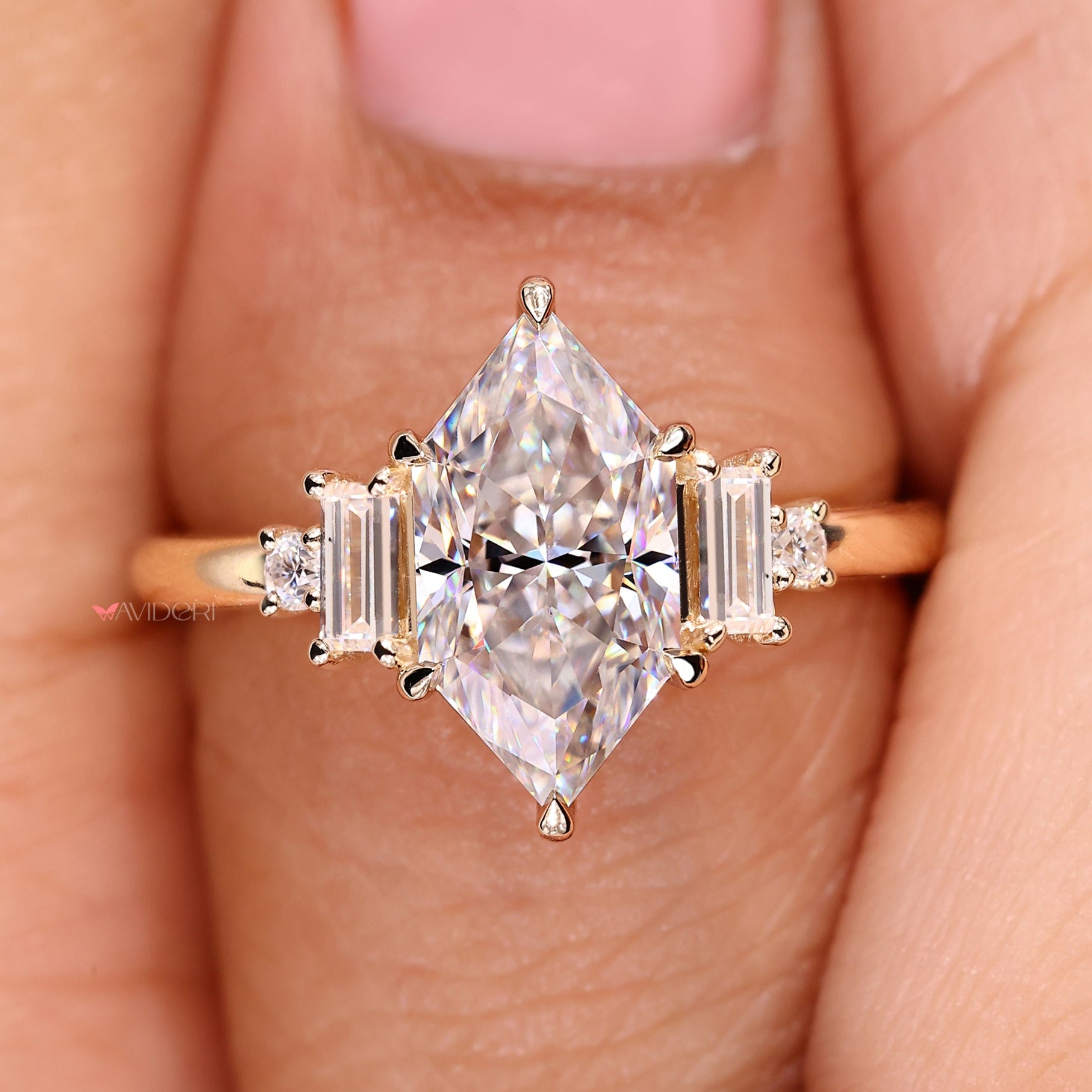 Dutch marquise engagement ring with baguette and round side stone.