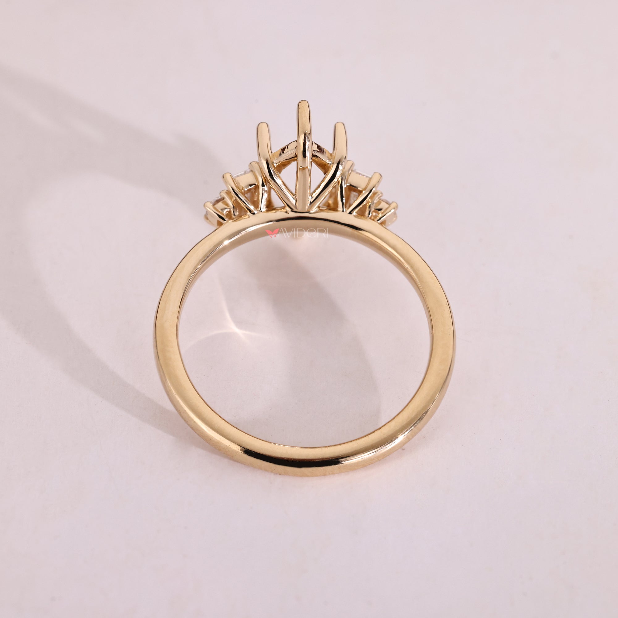 Yellow gold prong set engagement ring with five diamonds.
