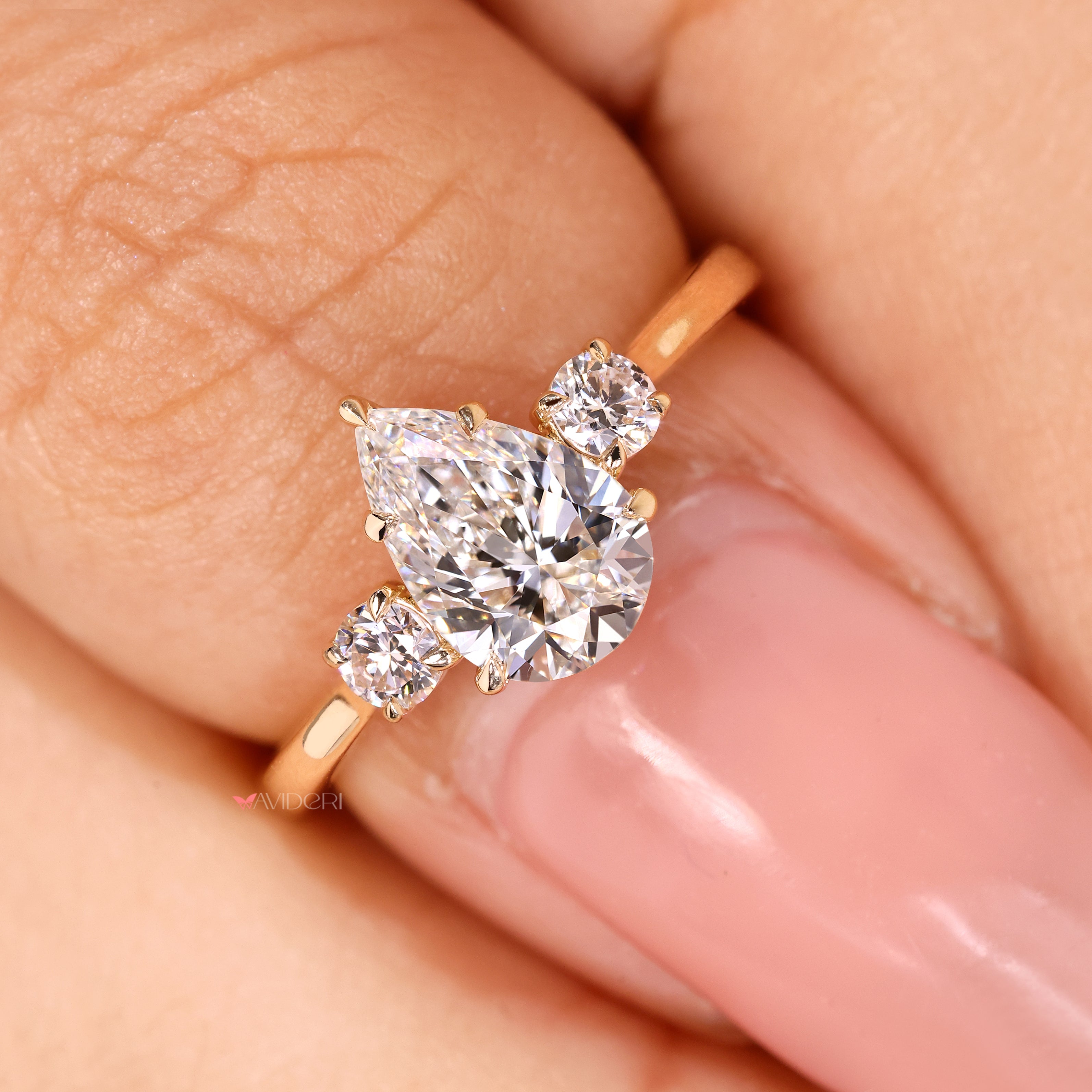 IGI certified pear engagement ring with round side diamonds
