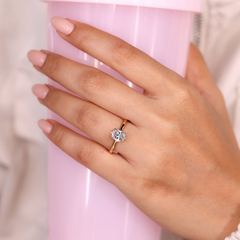 Oval ring with round diamond hidden halo.
