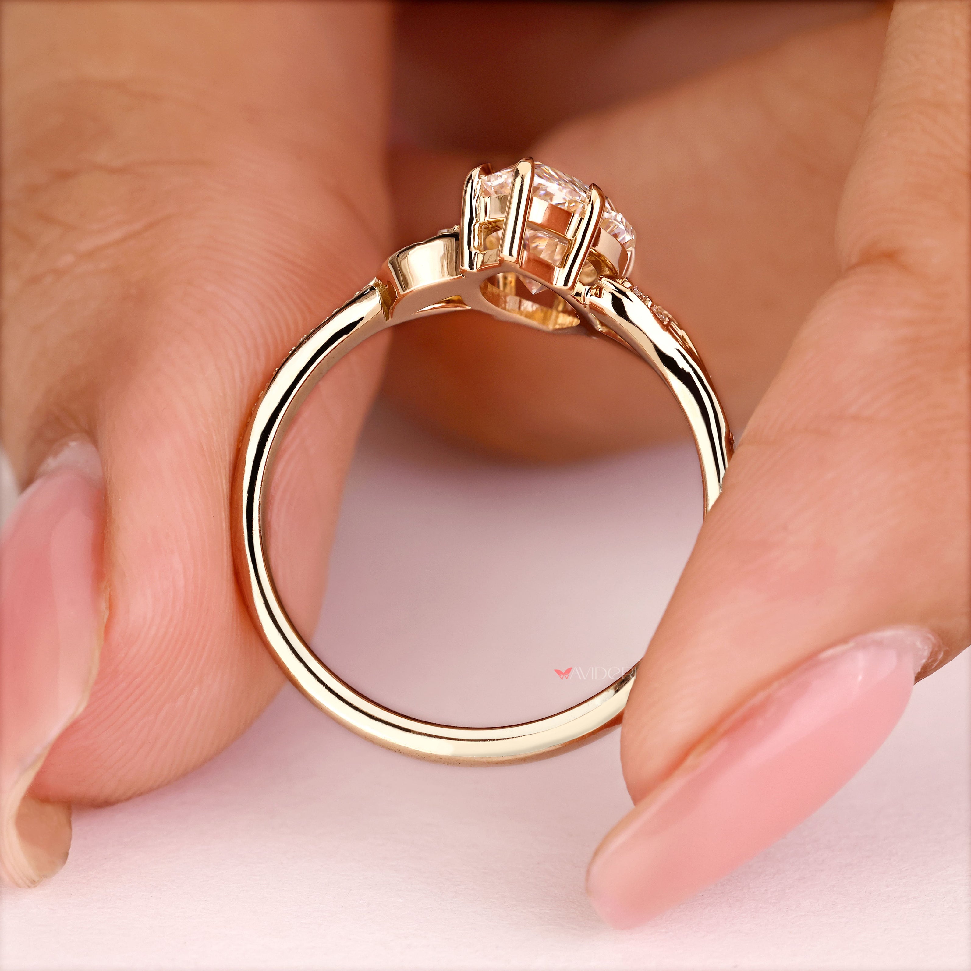 Marquise diamond engagement ring with round side stone accents
