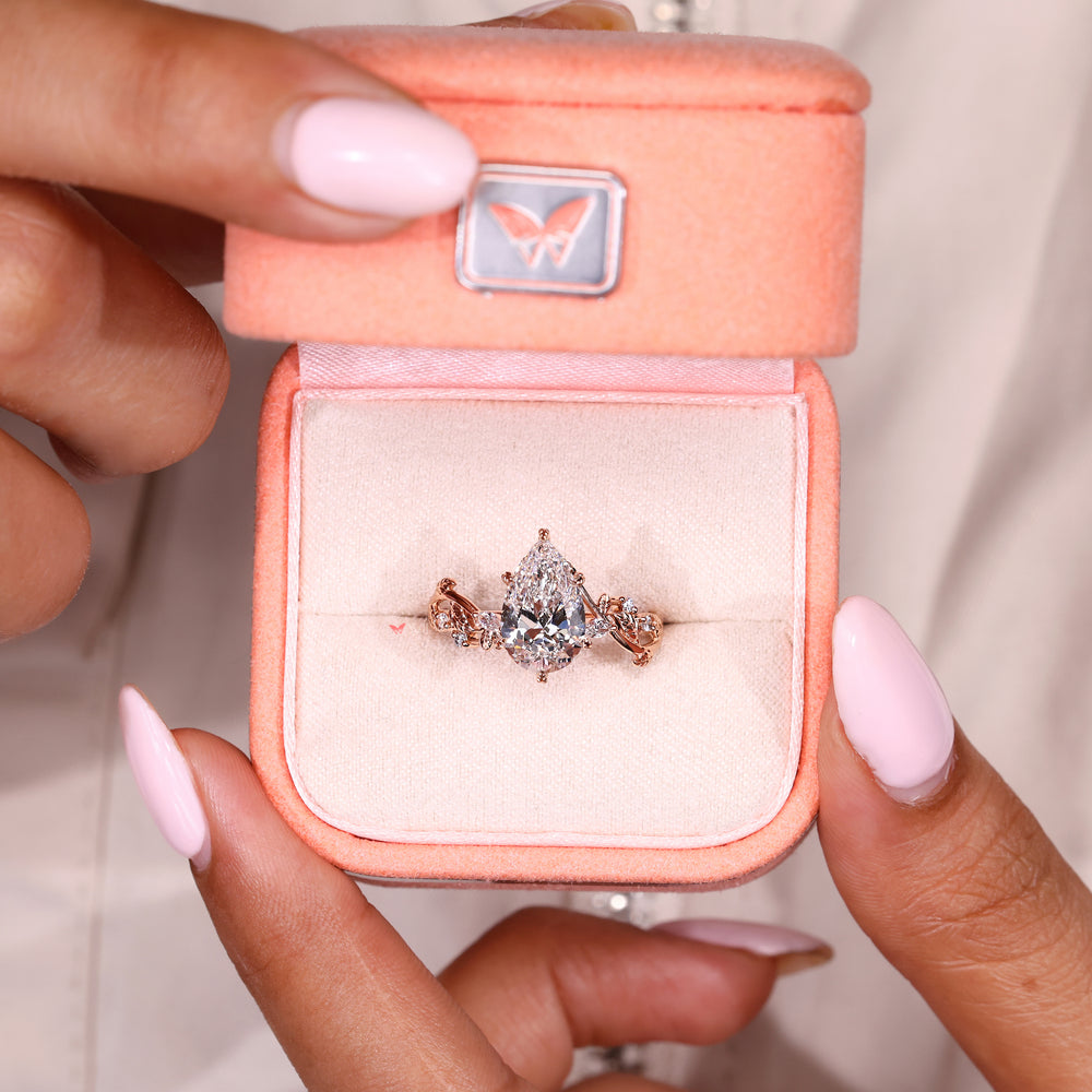 Pear diamond engagement ring with leaf inspired prong setting

