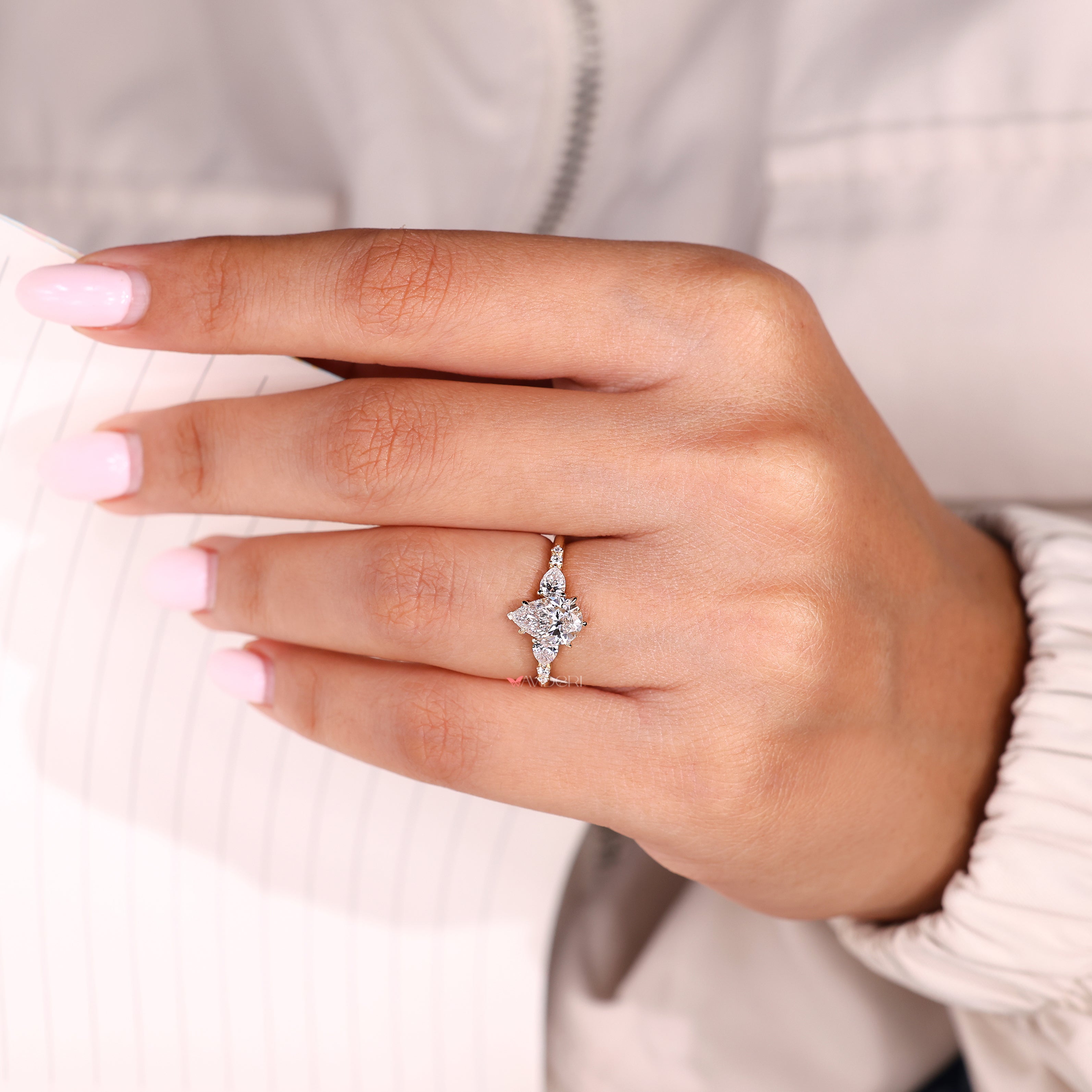 Lab grown diamond ring with pear and round accents
