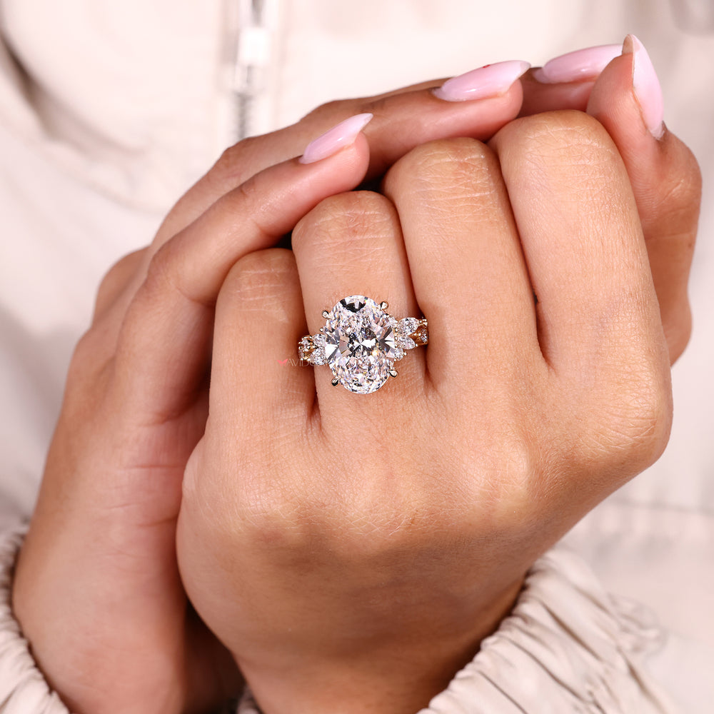 Oval cut diamond ring with marquise side stones.
