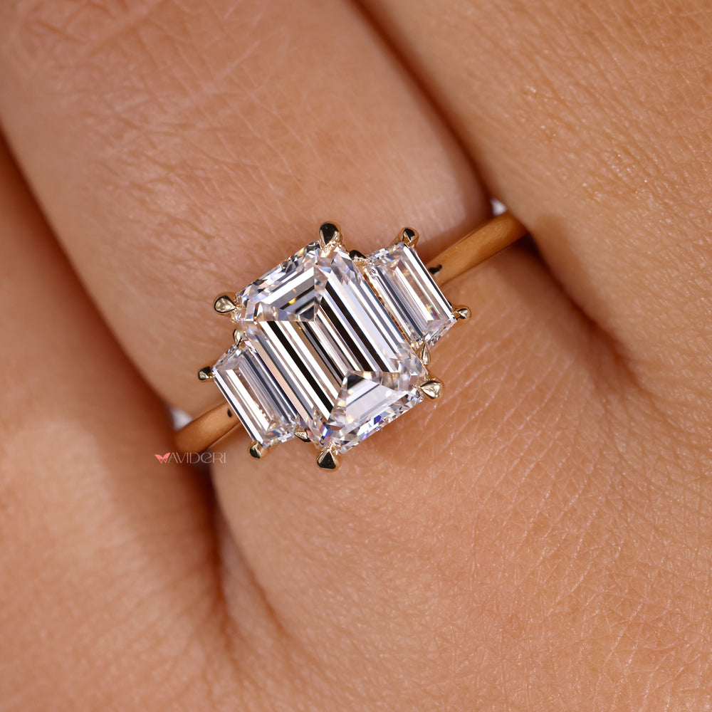 Three stone engagement ring featuring an emerald cut diamond for lasting beauty.
