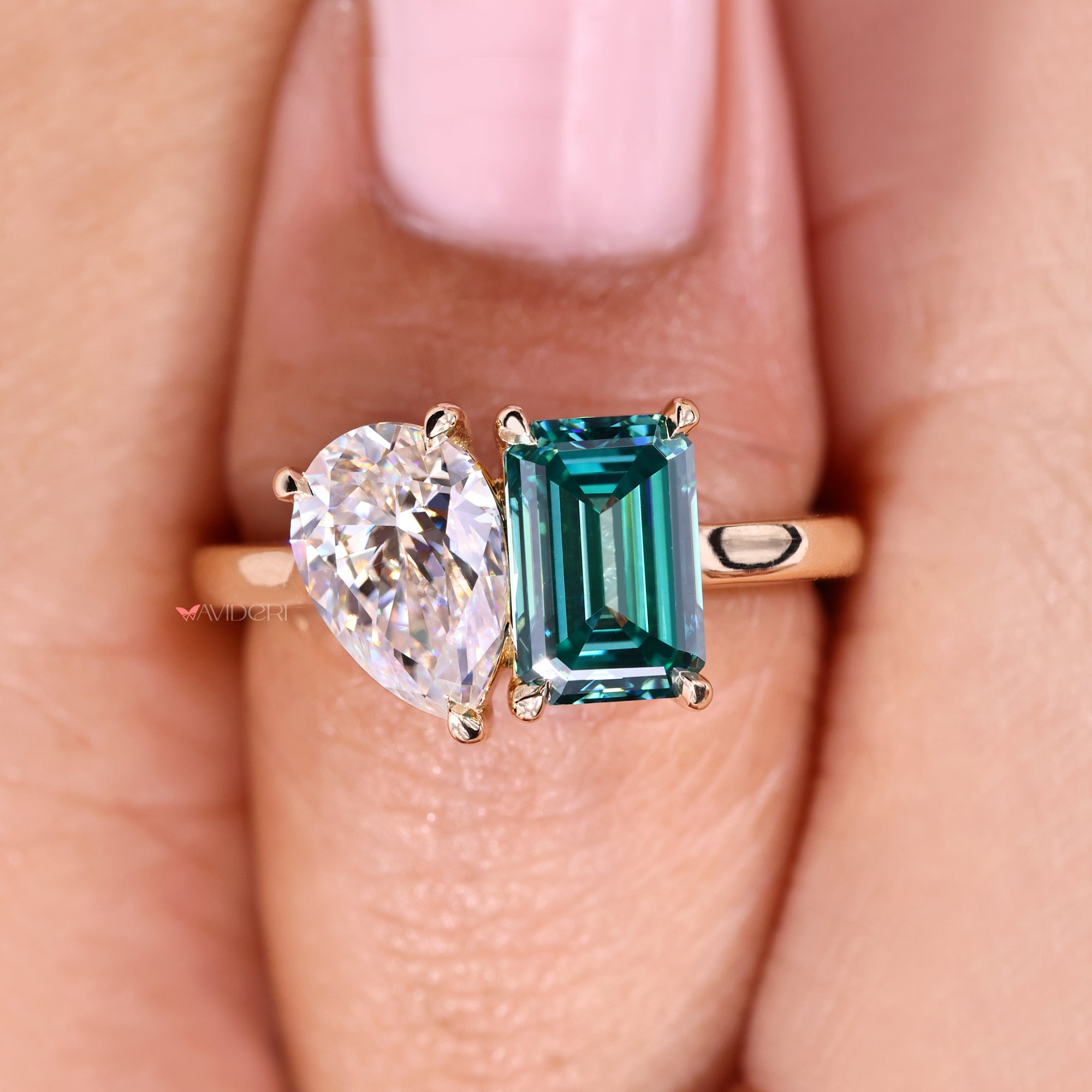 Avideri ring with pear and emerald cut in cathedral setting.
