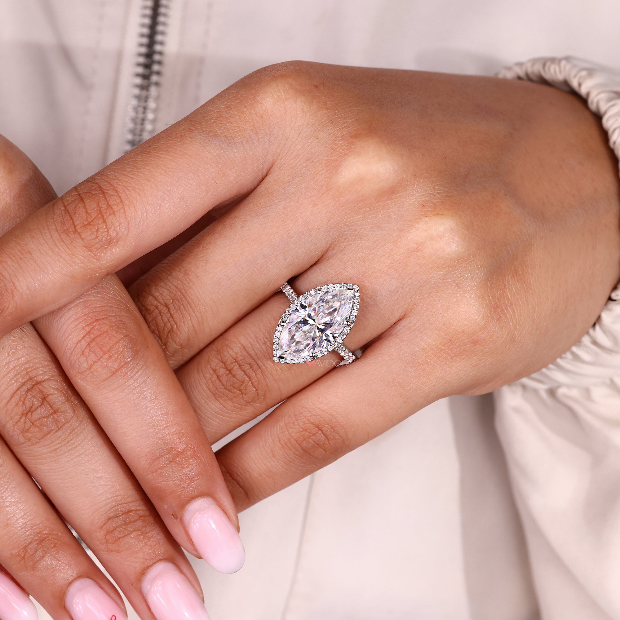 Round cut moissanite marquise engagement ring with halo.