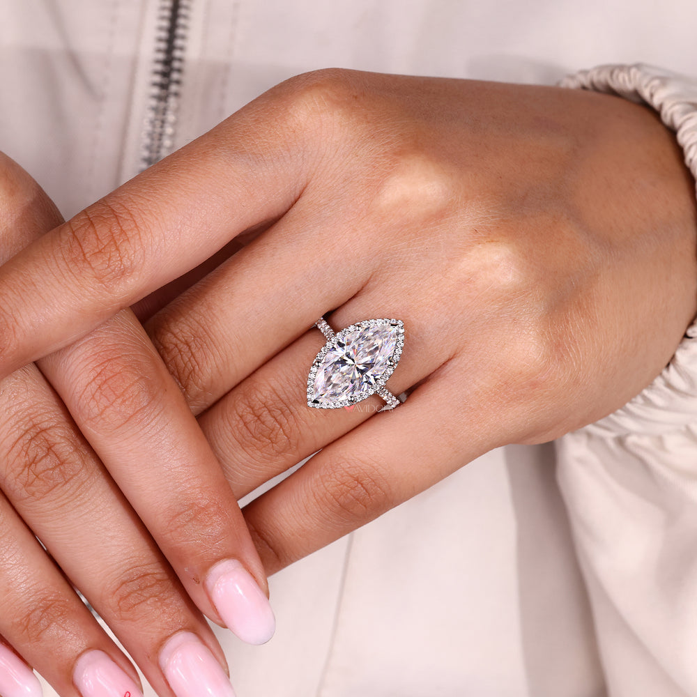 Round cut moissanite marquise engagement ring with halo.