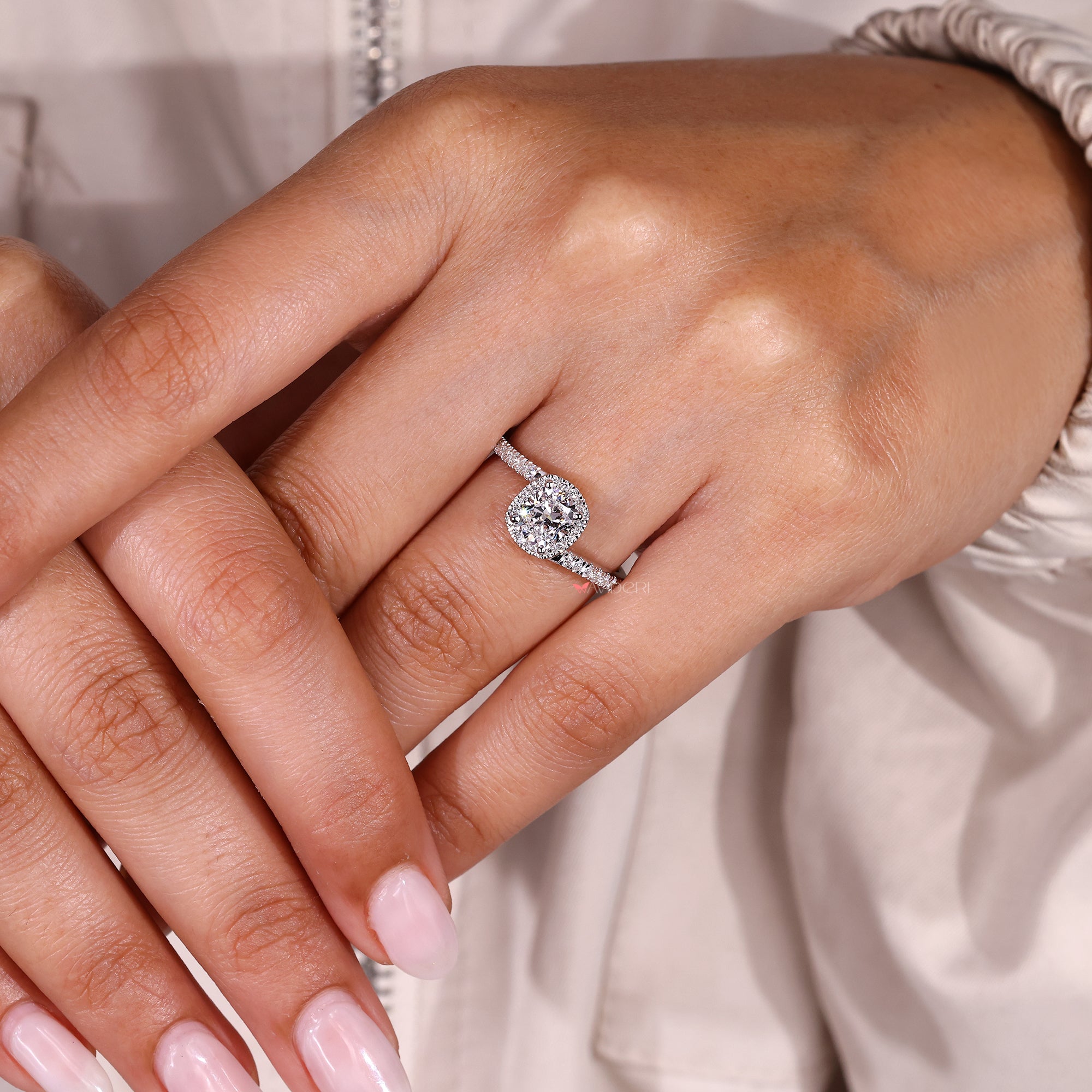 Elegant cushion diamond ring with sparkling pave band.