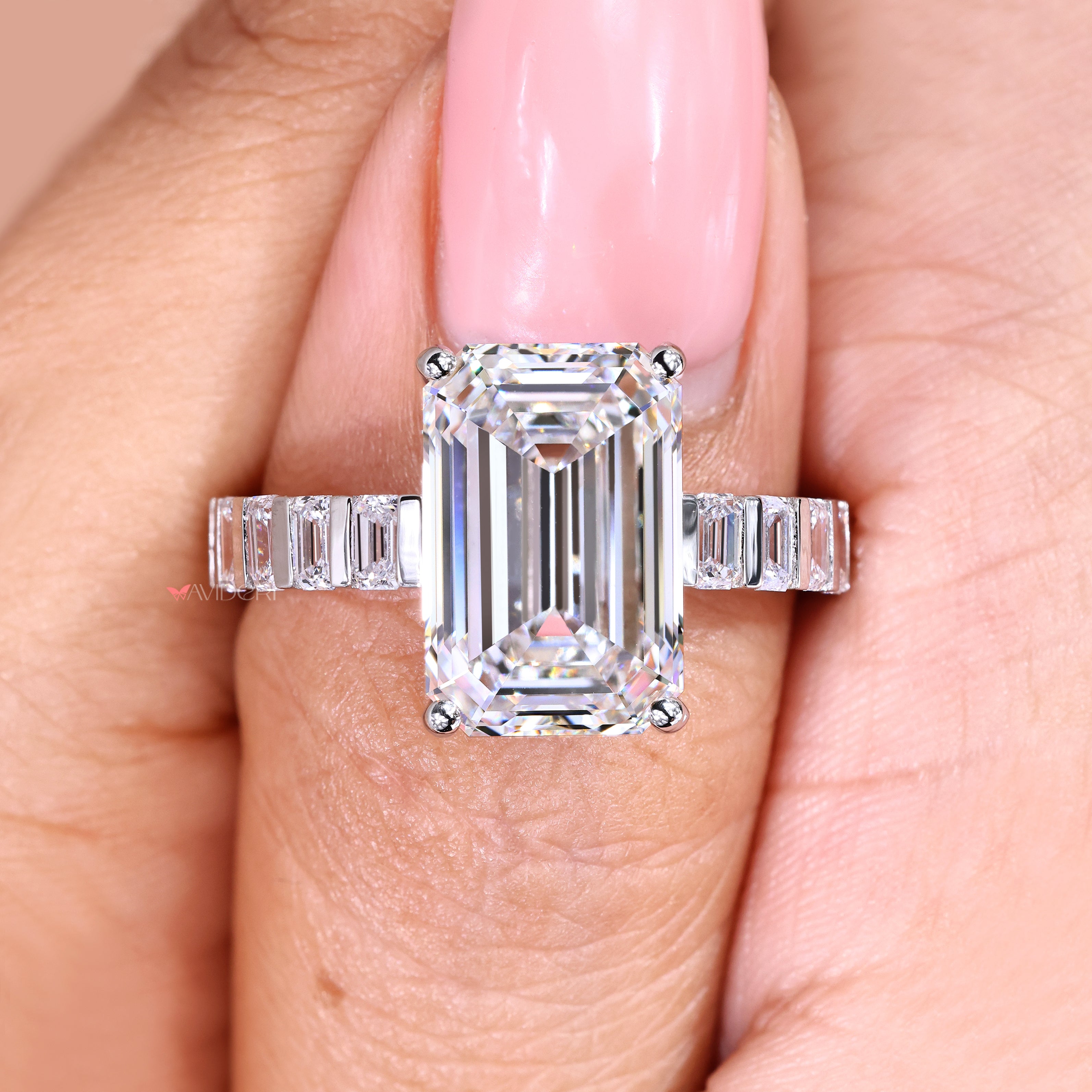 Emerald cut diamond ring with four prongs and bar setting
