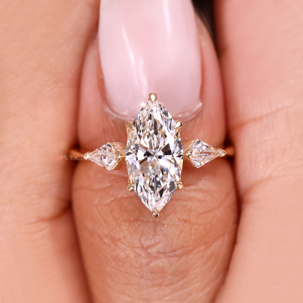 Marquise diamond ring with pointed kite side stones.
