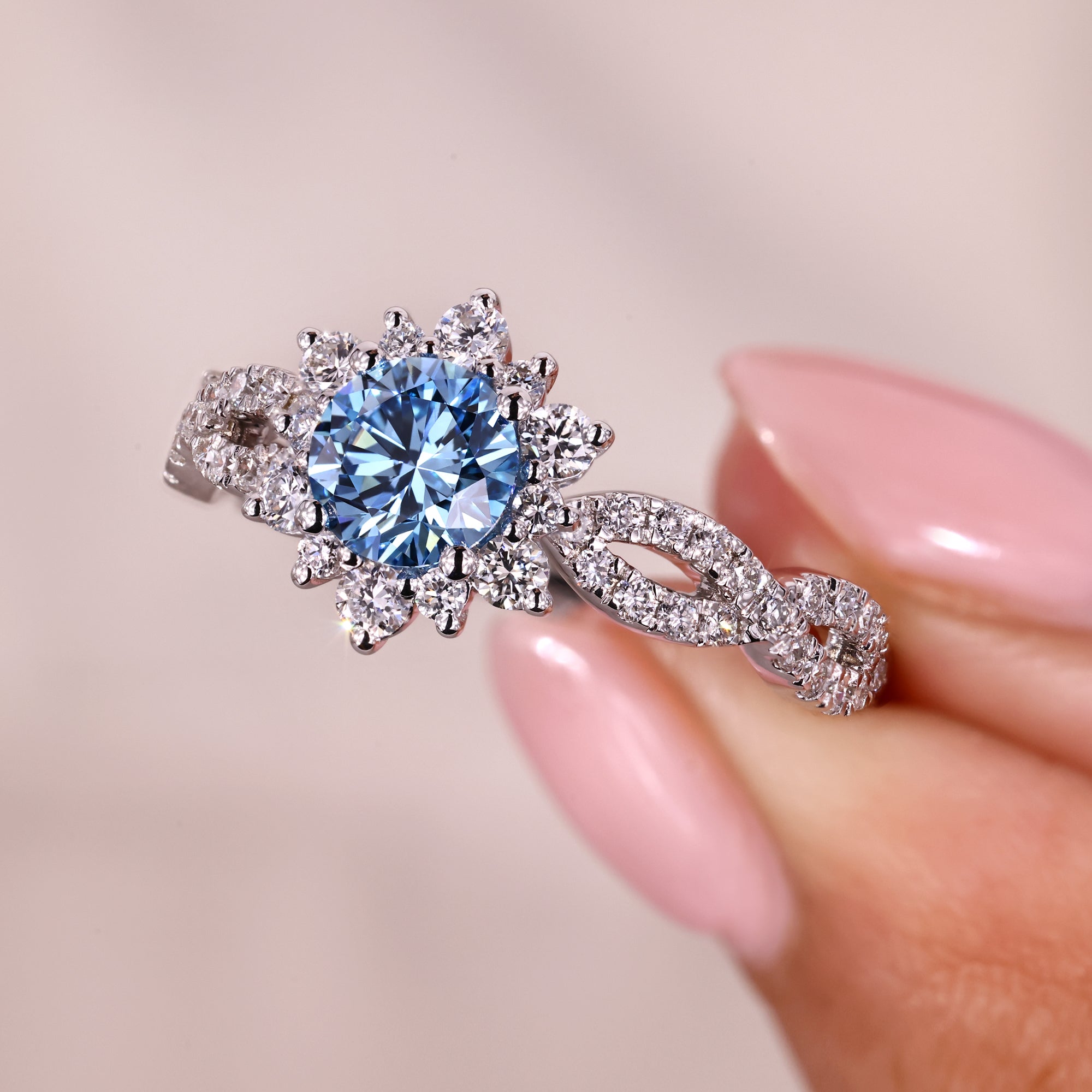 Blue diamond engagement ring with round cut center diamond.
