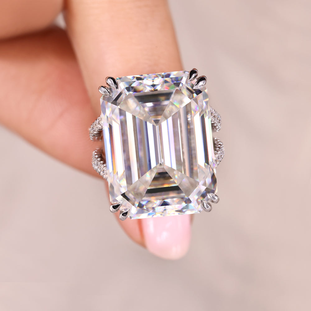 Emerald cut engagement ring with round moissanite accents.