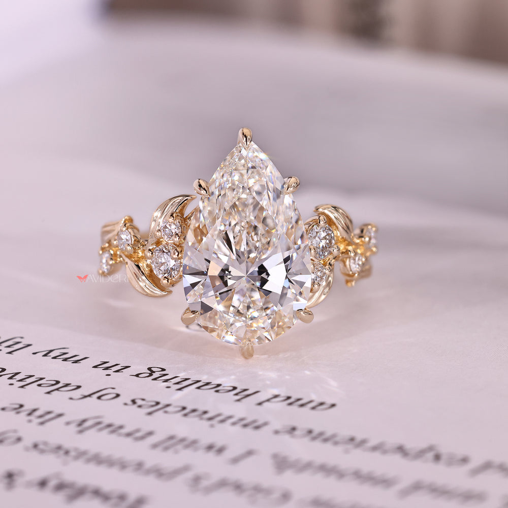 Pear cut ring with nature inspired cluster design.
