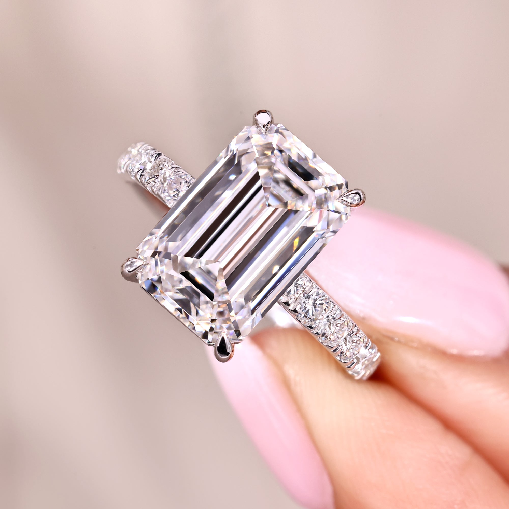 Emerald cut diamond ring with four claw prong setting.
