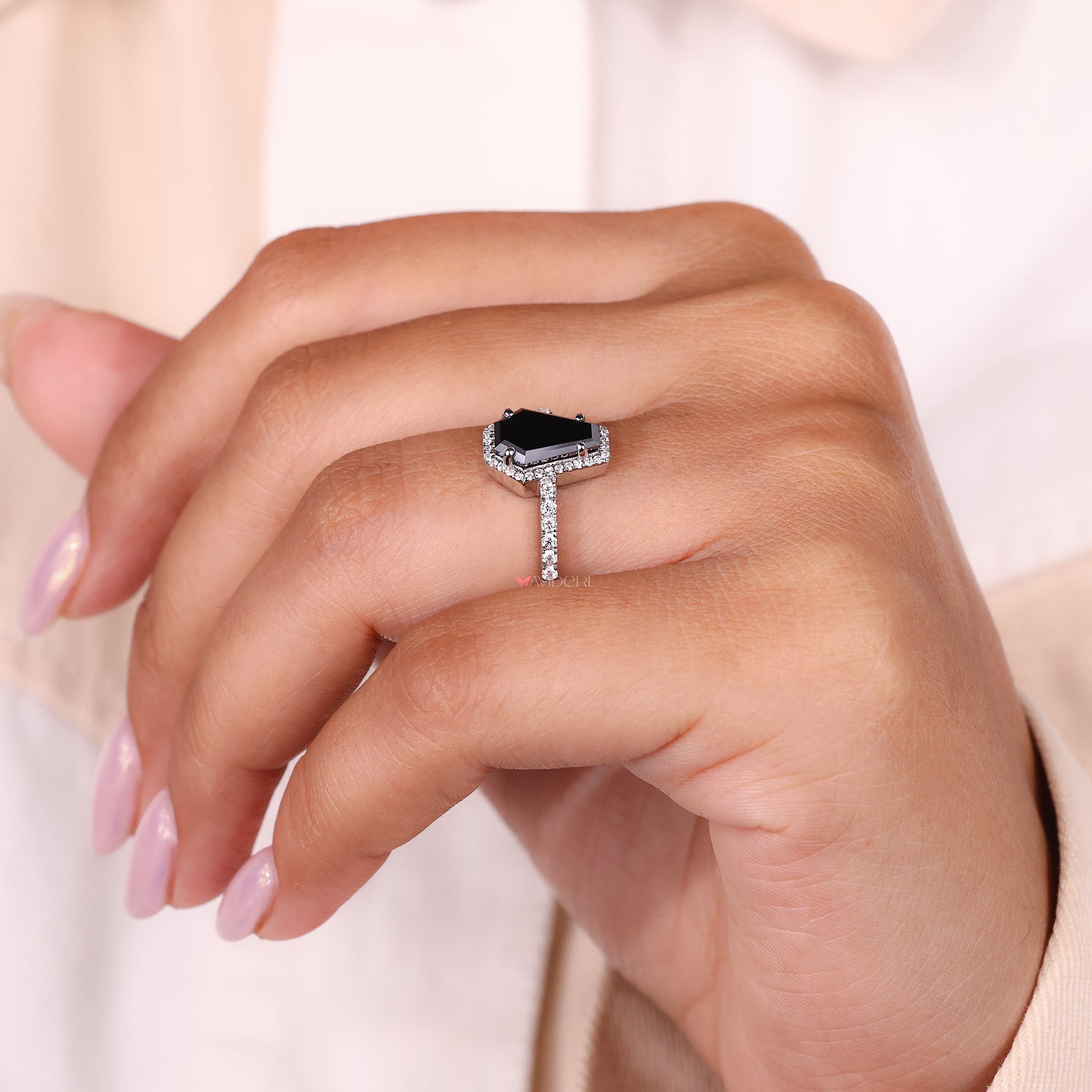 Halo engagement ring with a unique setting and bold center stone.