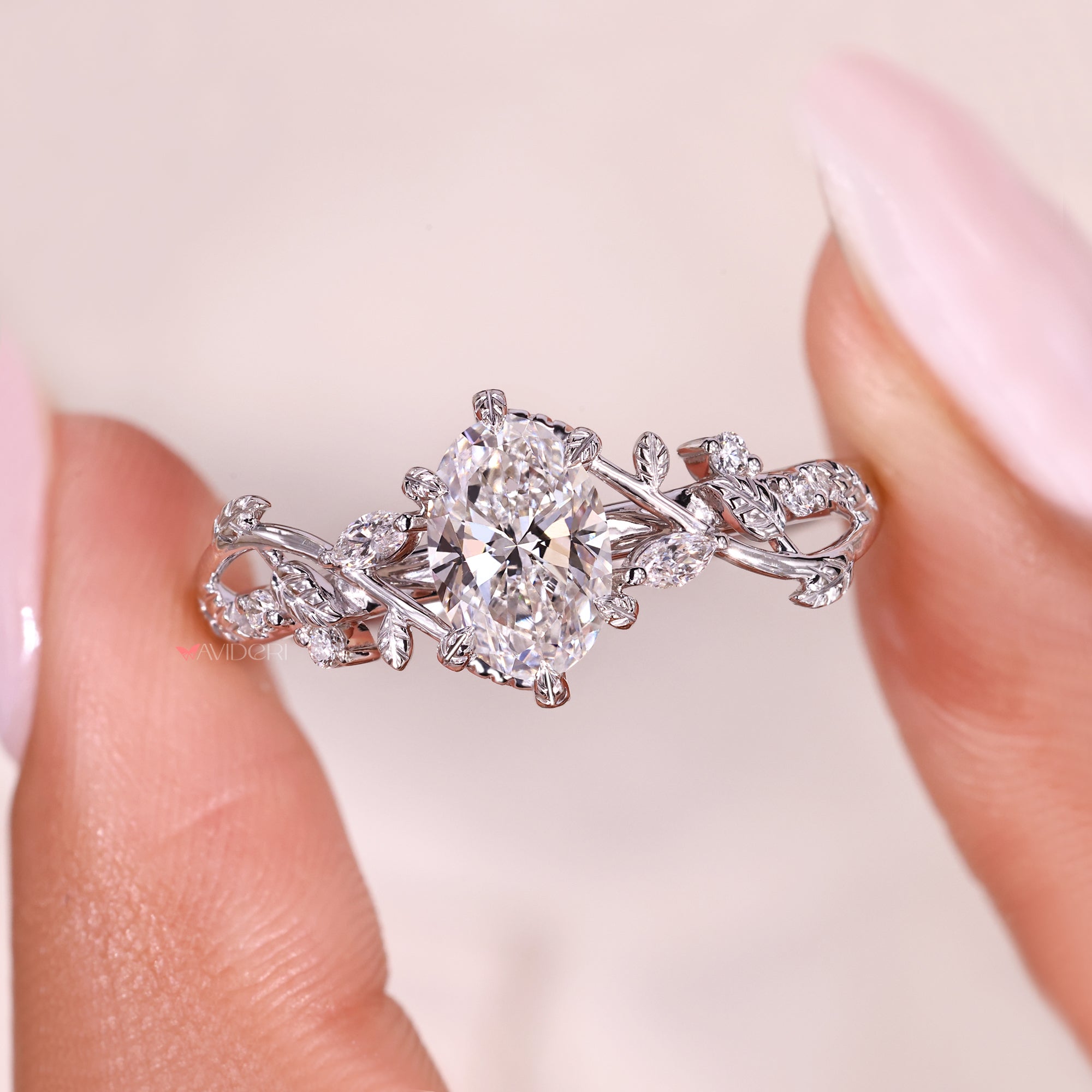 Oval cut diamond ring with marquise side diamonds and filigree work.
