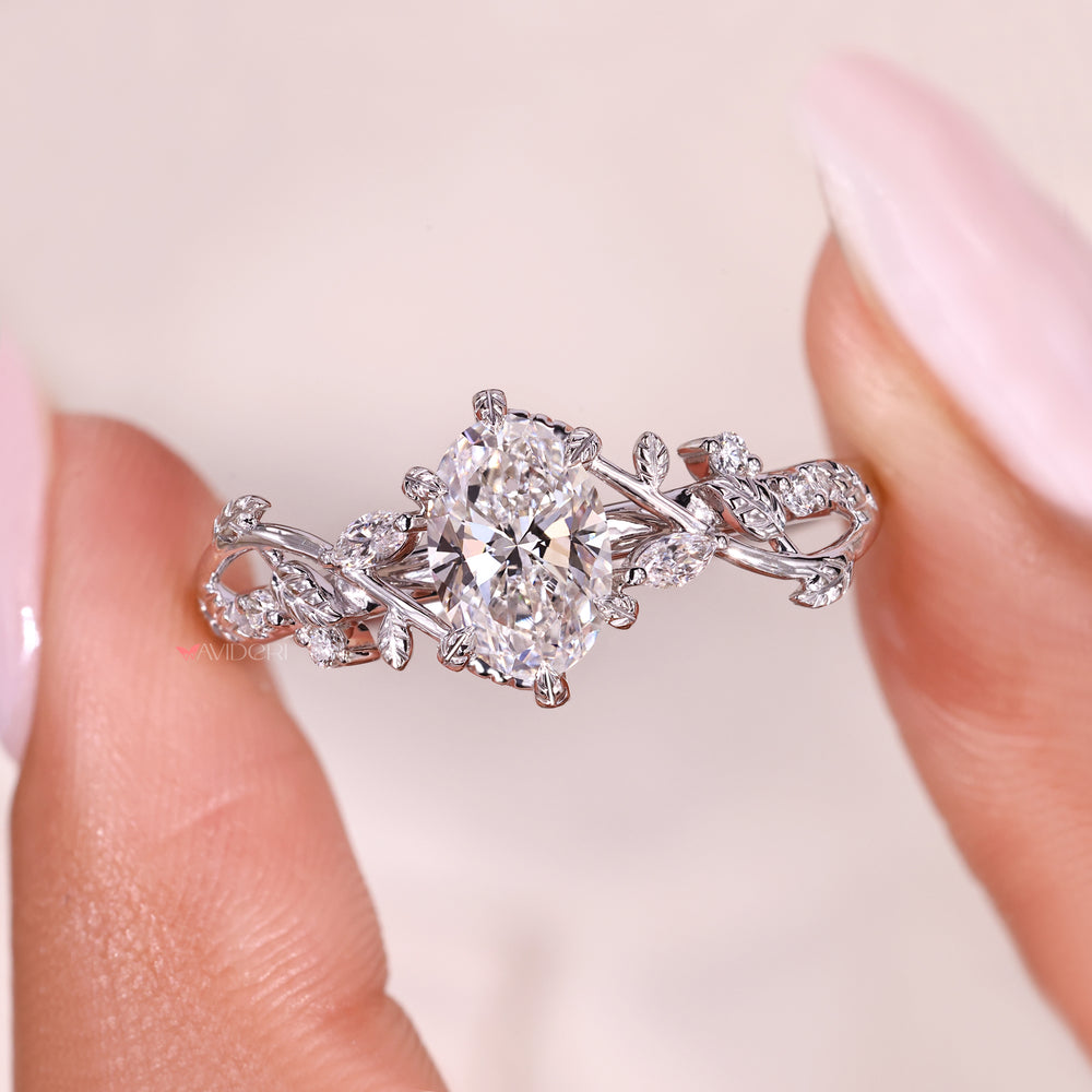 Oval cut diamond ring with marquise side diamonds and filigree work.
