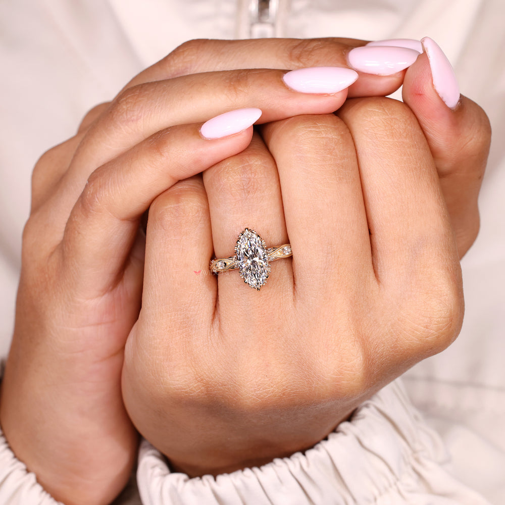 Marquise engagement ring with vintage details and pave accents
