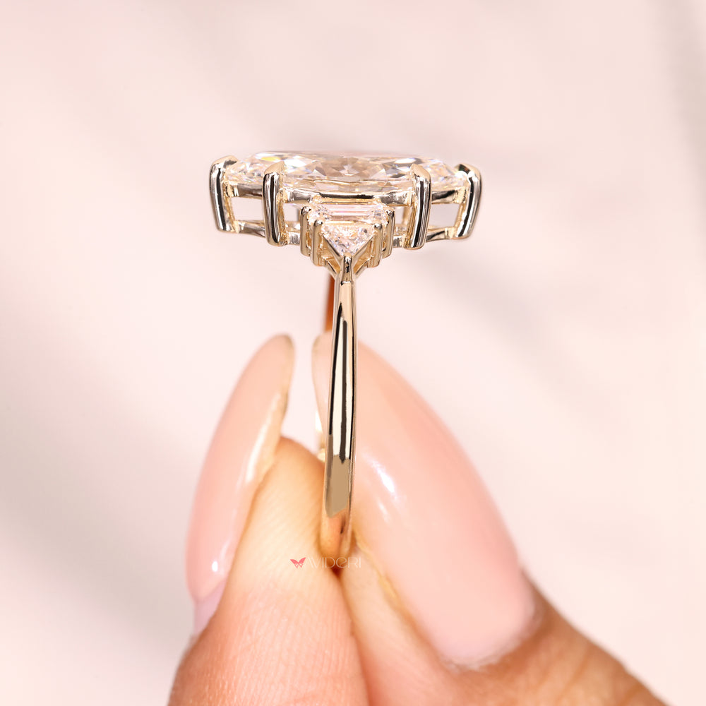 Five stone diamond ring with marquise center and accents.
