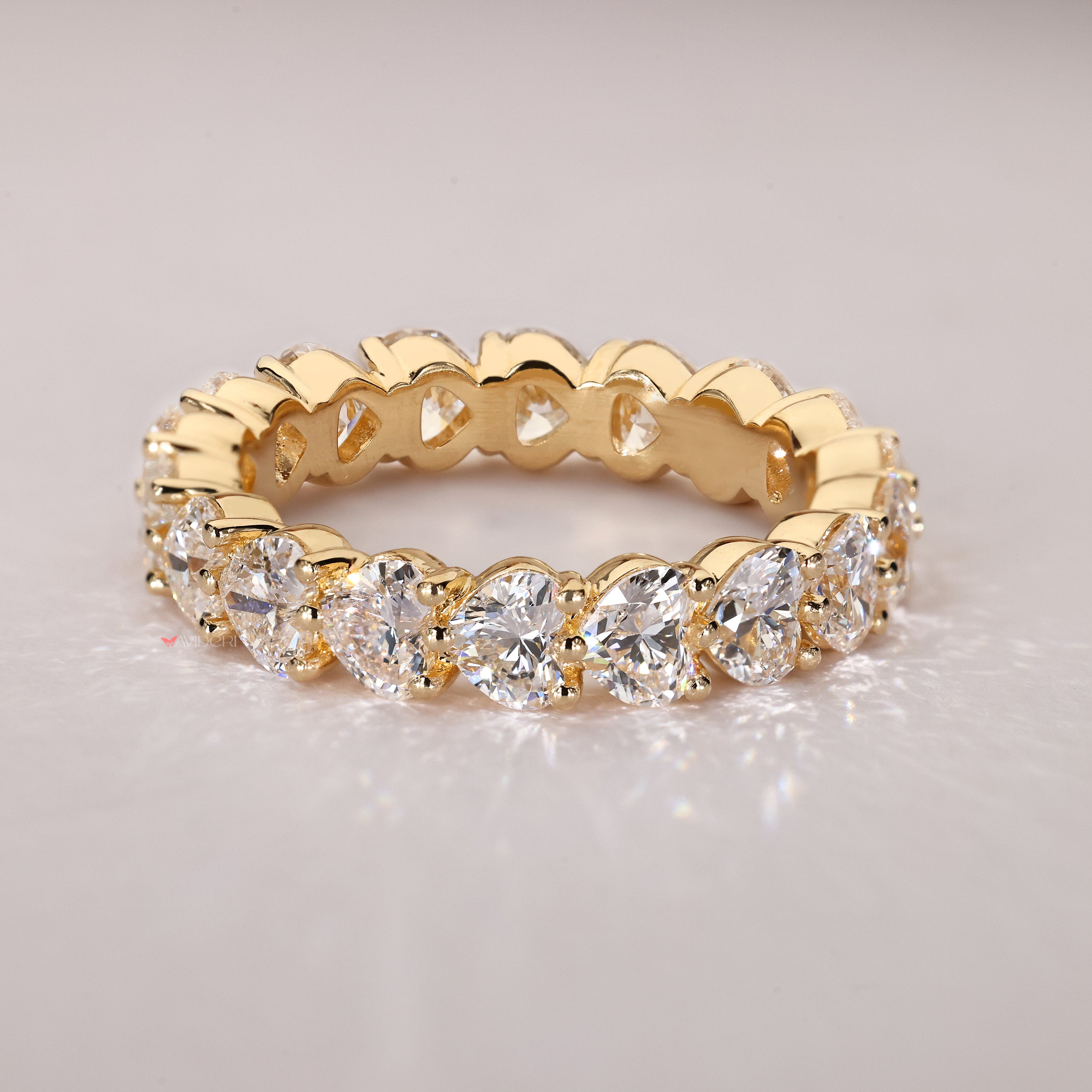 Shared prong heart diamond eternity band.

