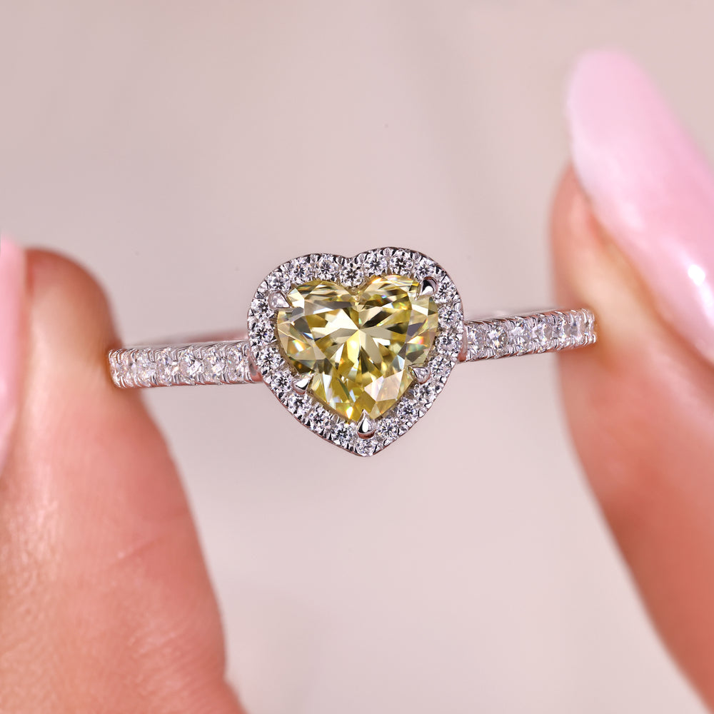 Heart cut moissanite ring with halo and pave style.