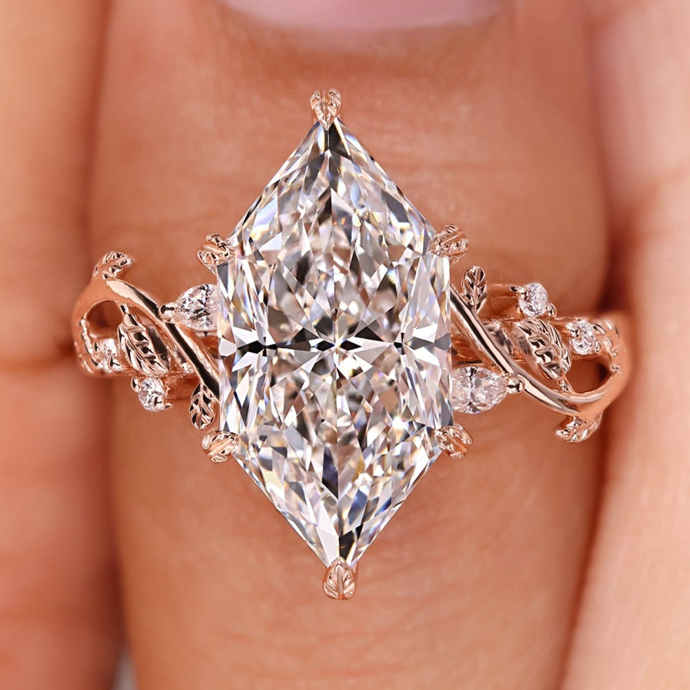 Nature inspired engagement ring with Dutch marquise diamond and leaf and vine detailing.
