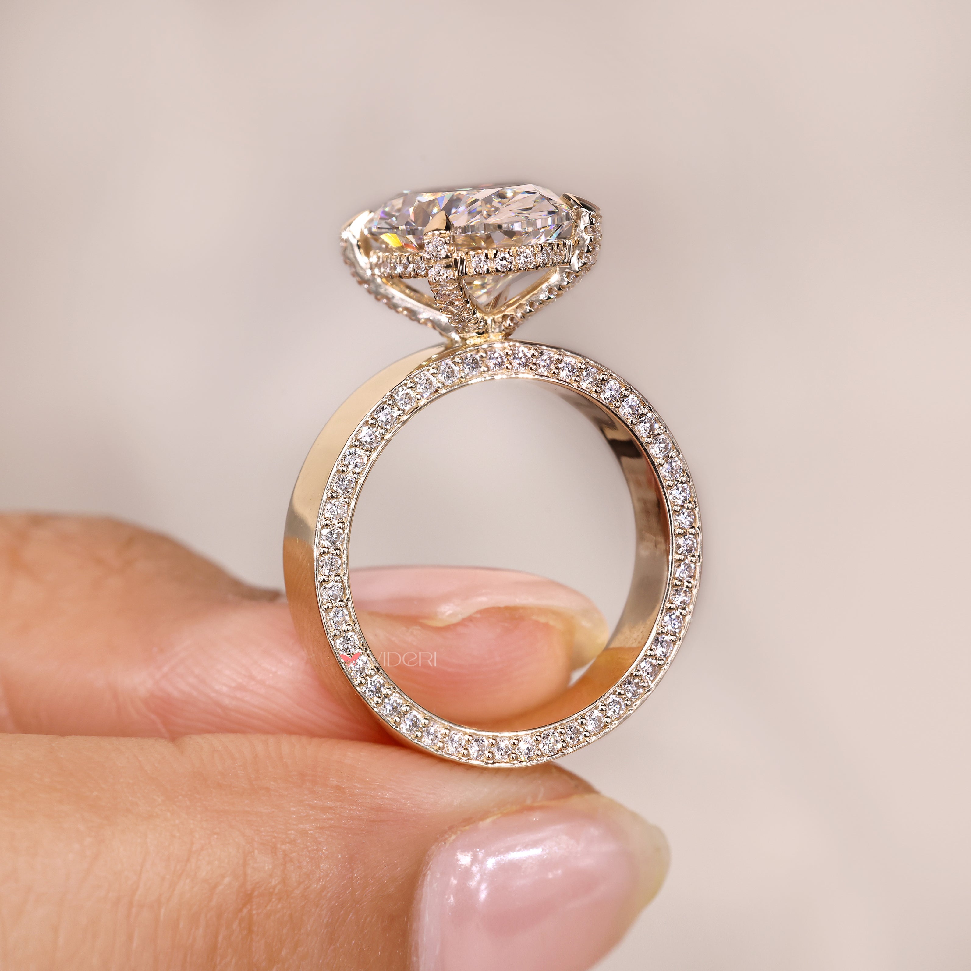 Hidden halo oval diamond ring claw prong set.
