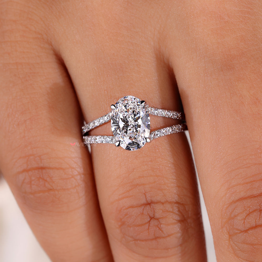 Oval cut diamond ring with round pave accents.
