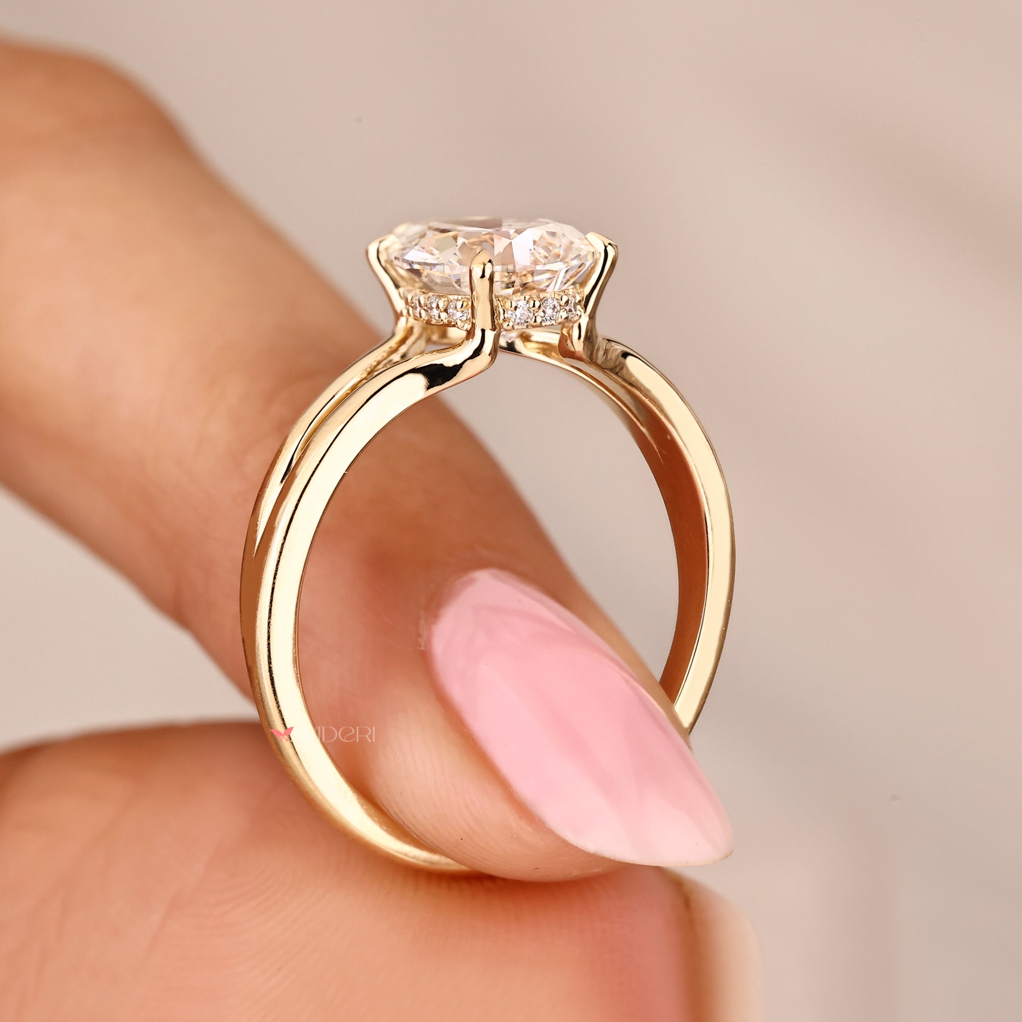 Pear cut diamond solitaire ring with hidden halo and claw prong setting.