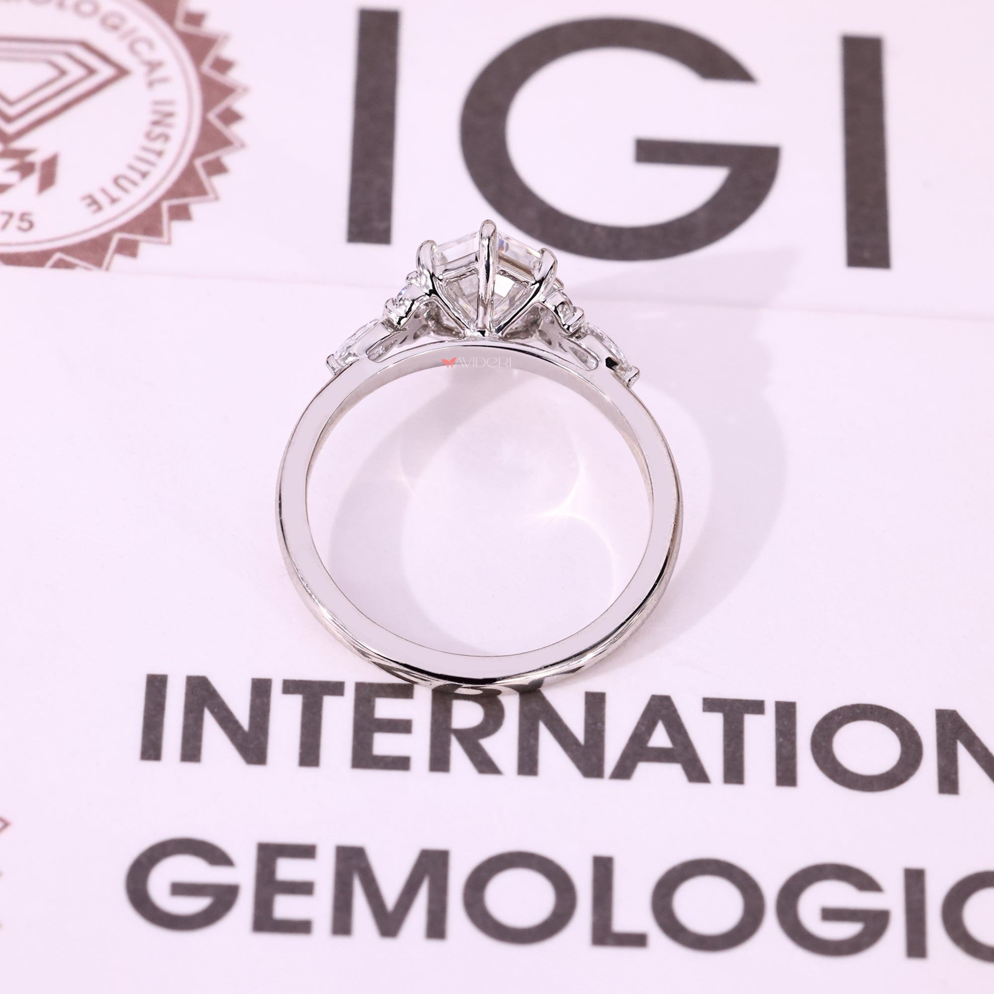 IGI certified seven stone ring with step cut center diamond.