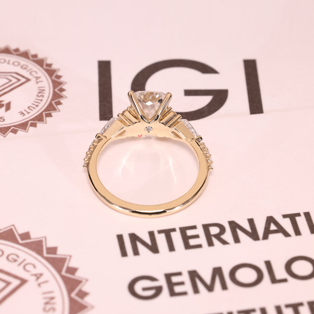 Cushion cut diamond ring with kite and round stones.

