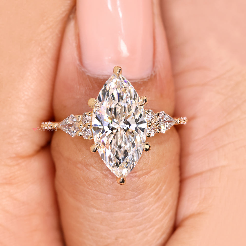 Round and kite side stone marquise diamond engagement ring.
