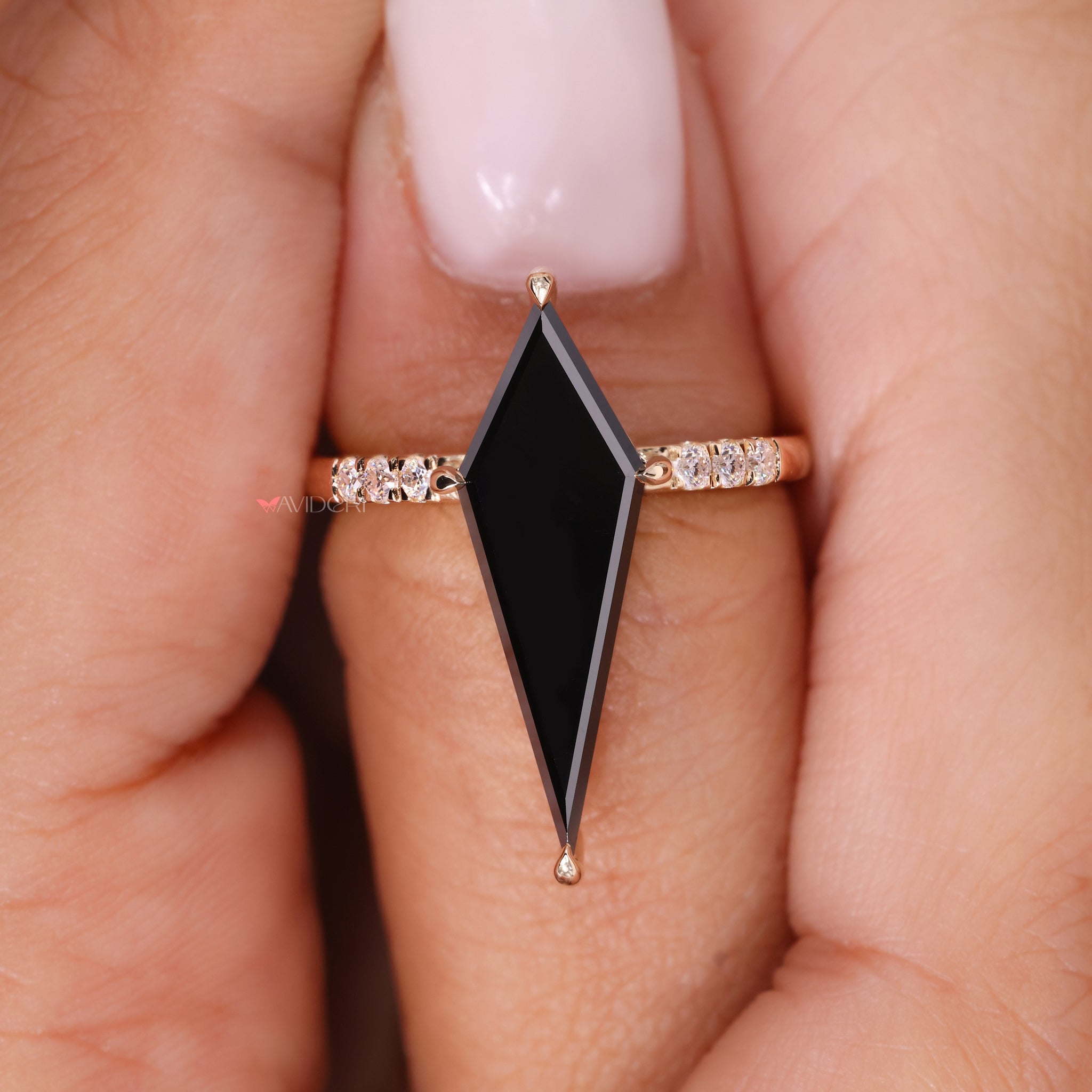 Yellow gold engagement ring with a kite cut moissanite center.
