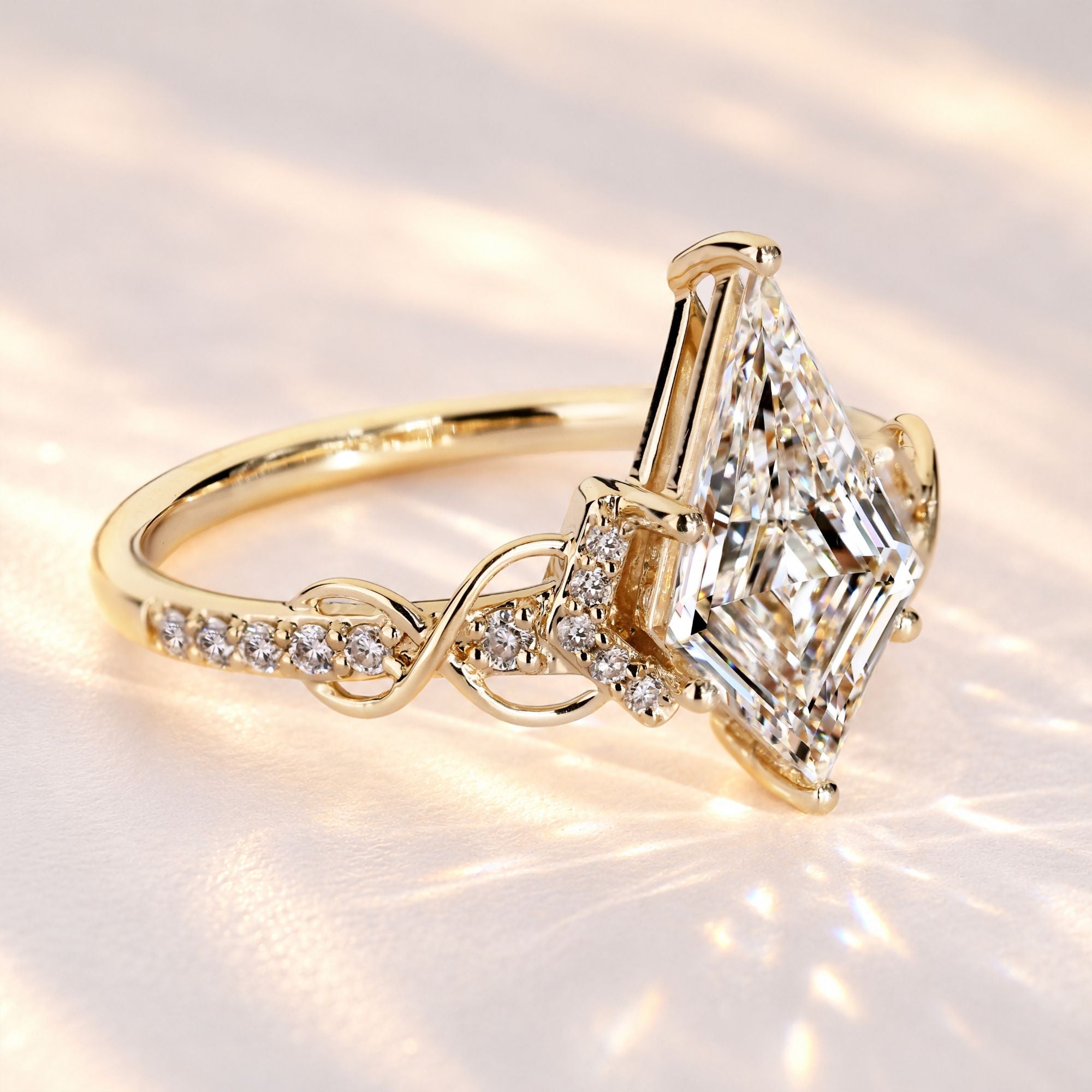 Kite cut engagement ring with round diamond accents.
