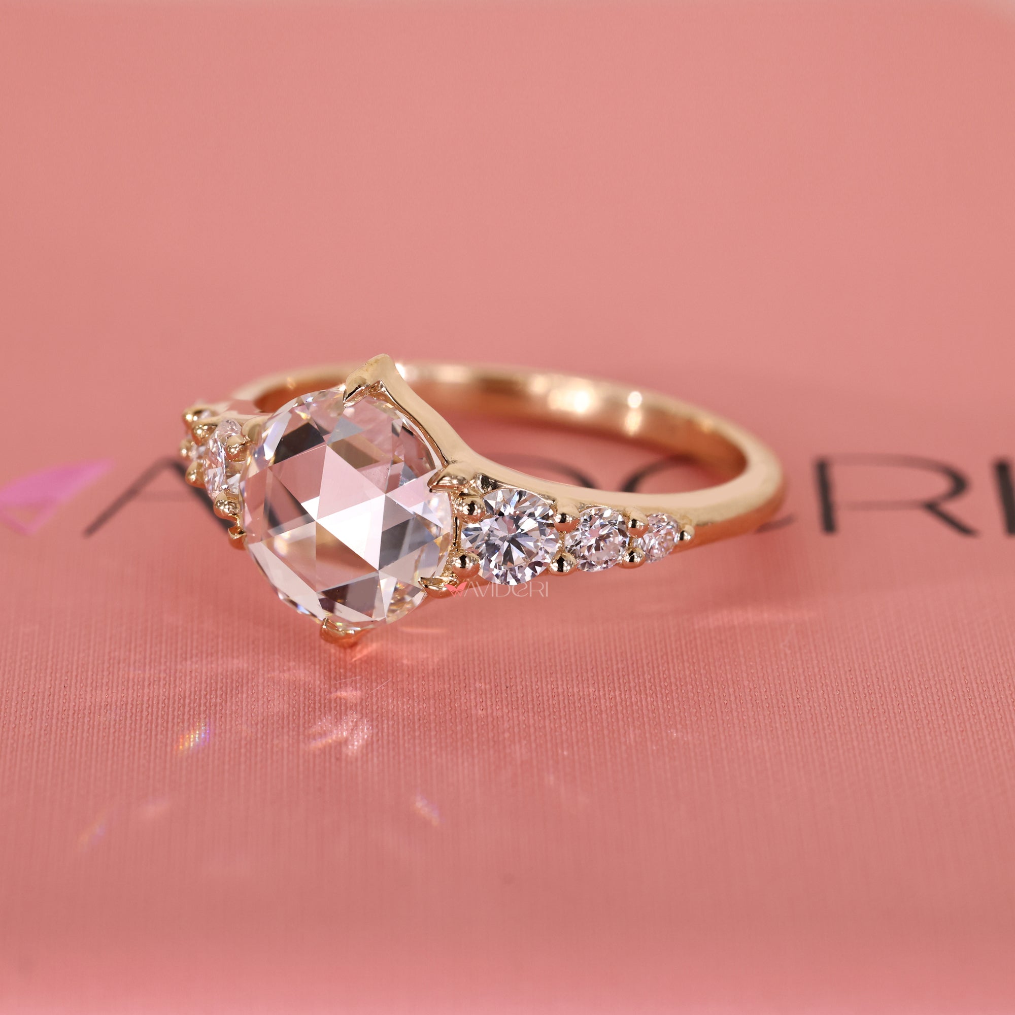 Six claw prong in tapered shank ring design.