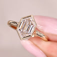 Hexagon step cut diamond ring with bezel setting ring.
